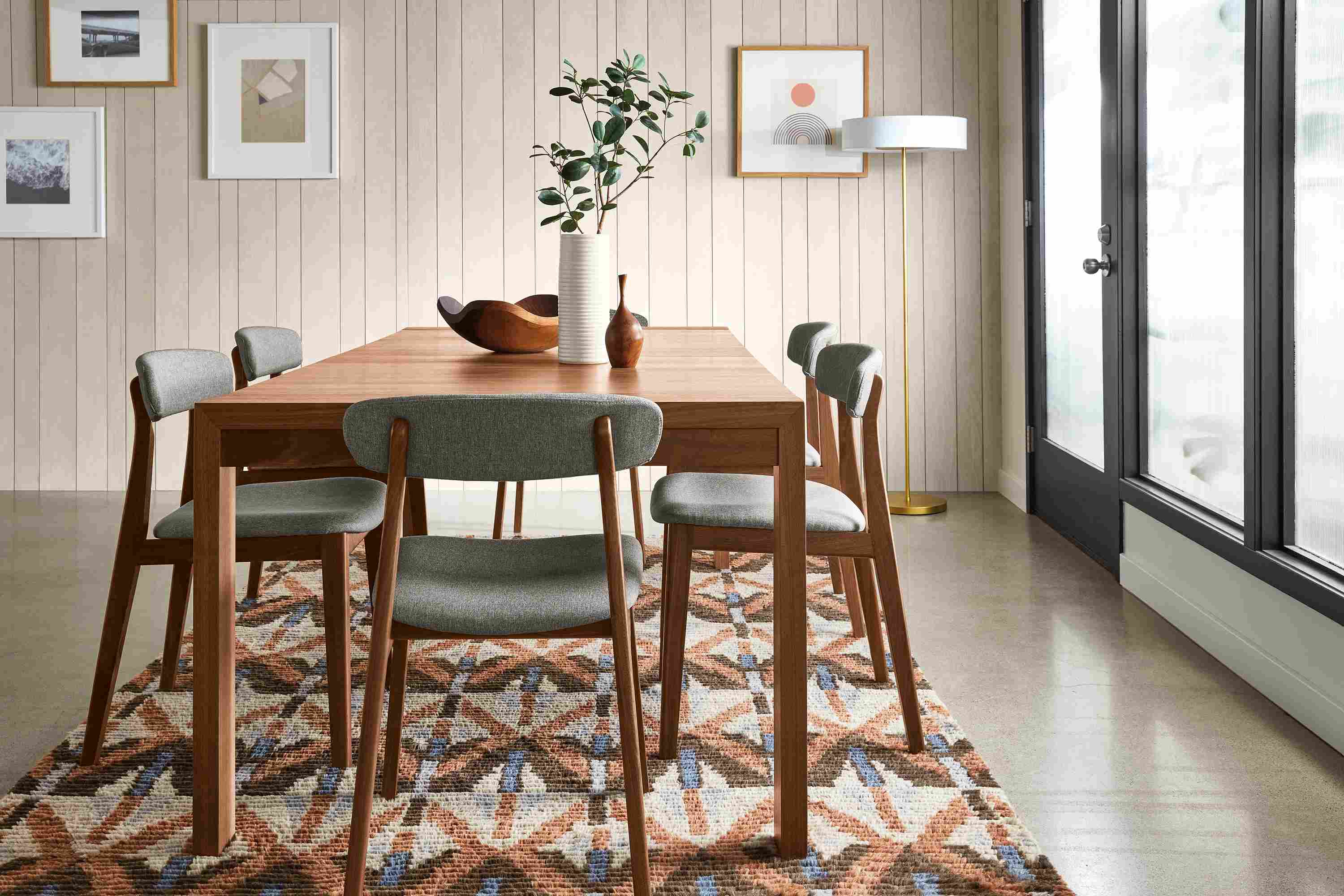 Living room with 80-wide Walsh extension dining table, 6 errol dining chairs, Rava rug.