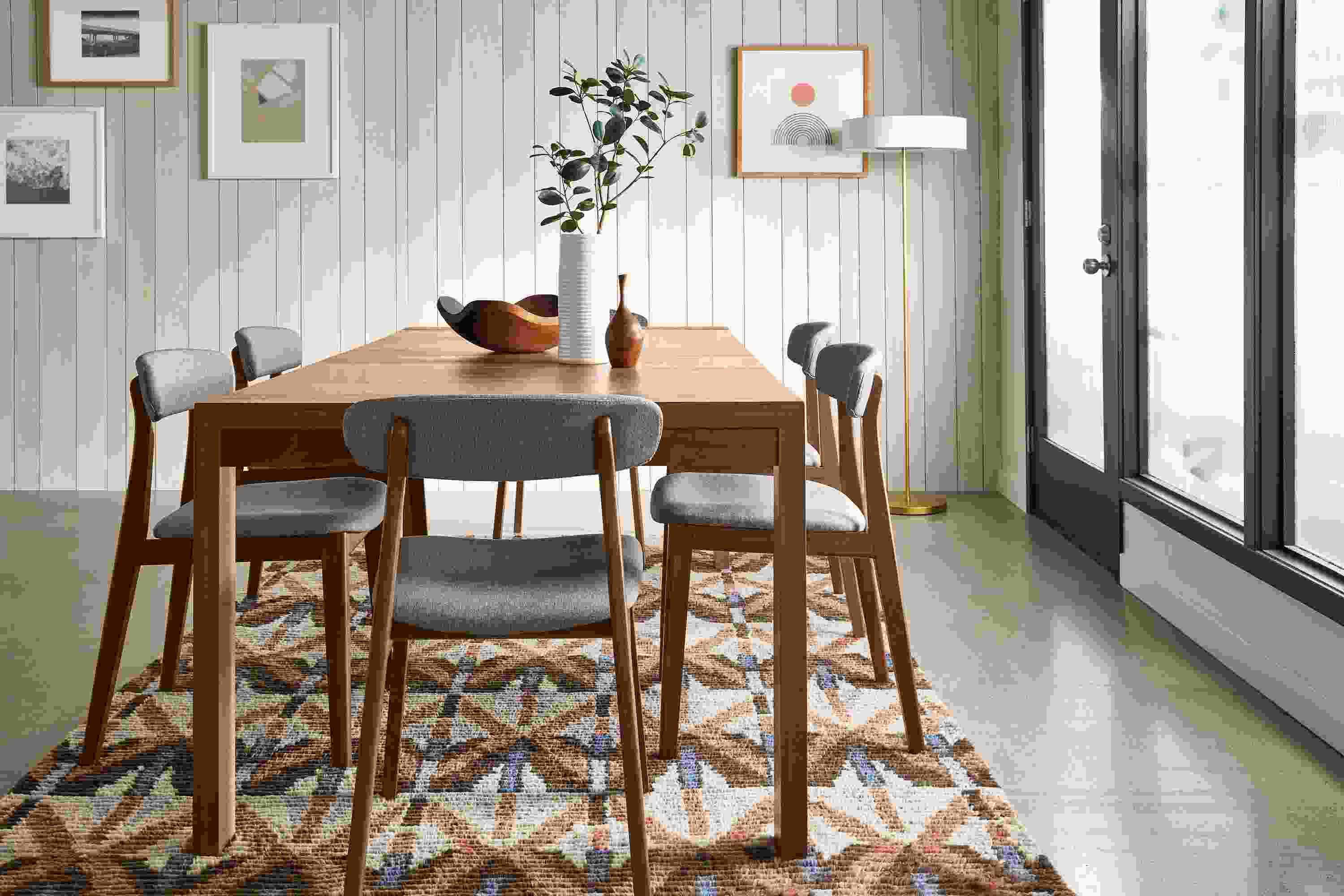 Living room with 80-wide Walsh extension dining table, 6 errol dining chairs, Rava rug.