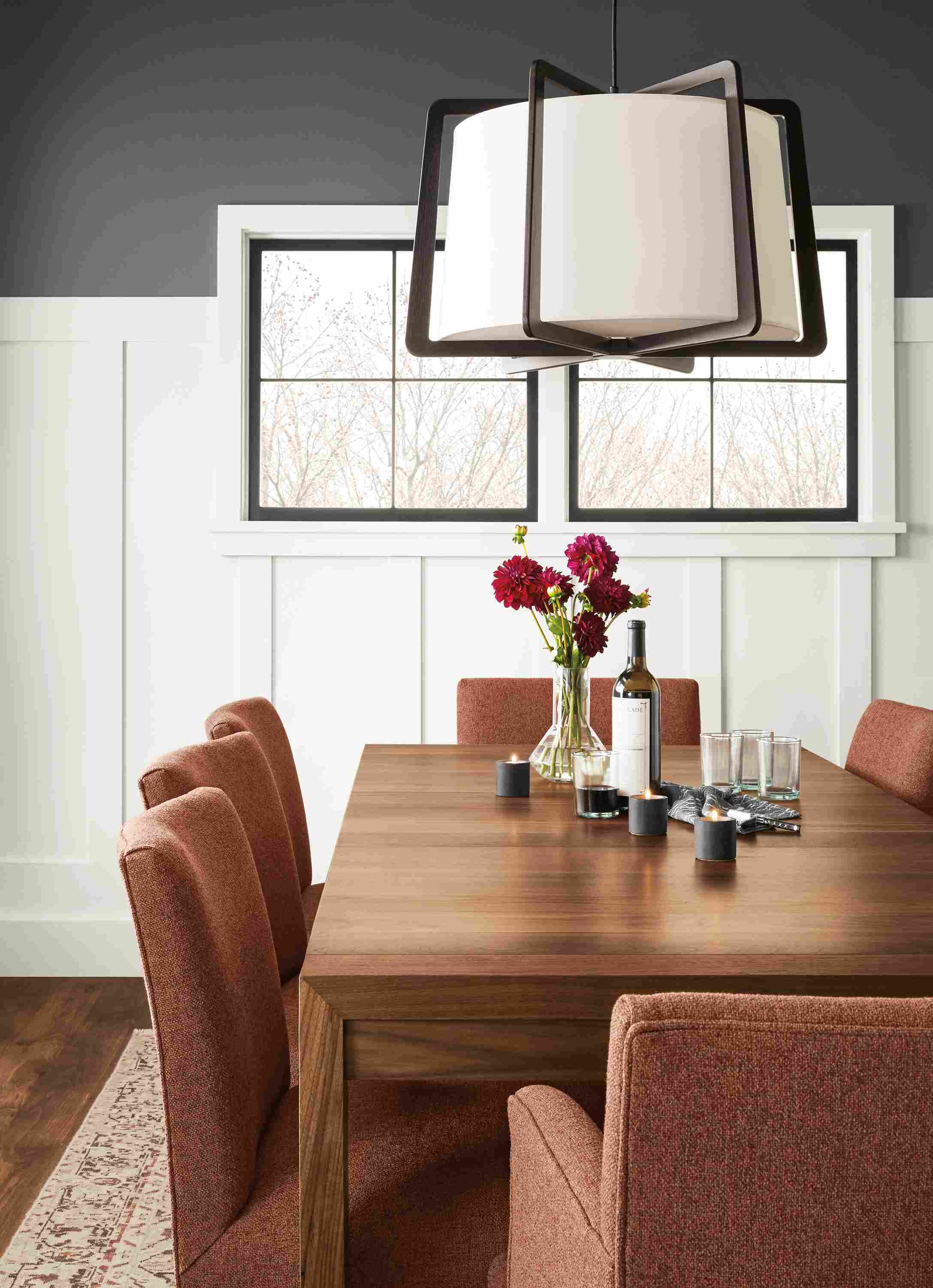 Detail of Walsh extension table in walnut in dining room with Marie chairs in Tatum Terracotta.