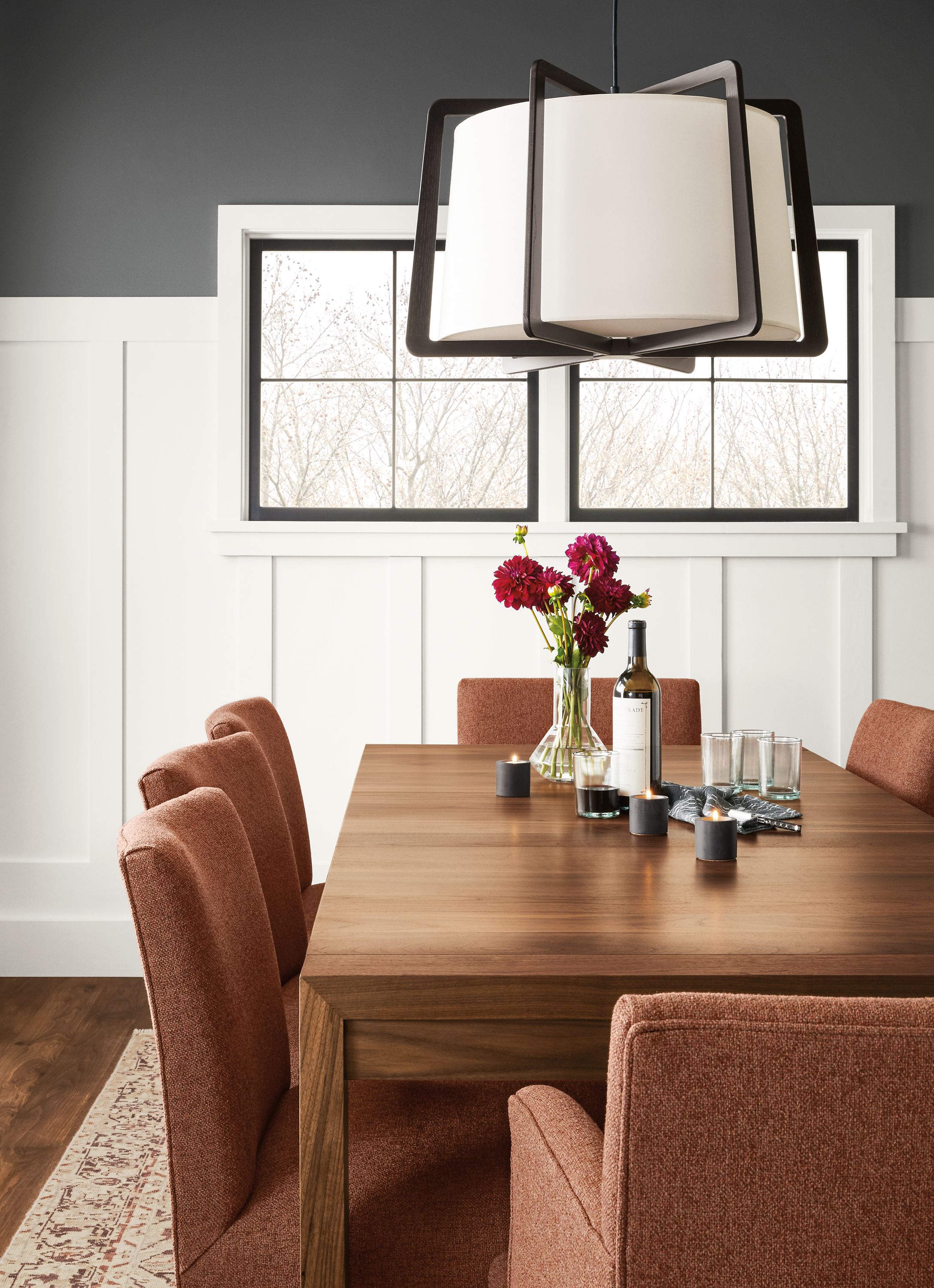 Detail of Walsh extension table in walnut in dining room with Marie chairs in Tatum Terracotta.