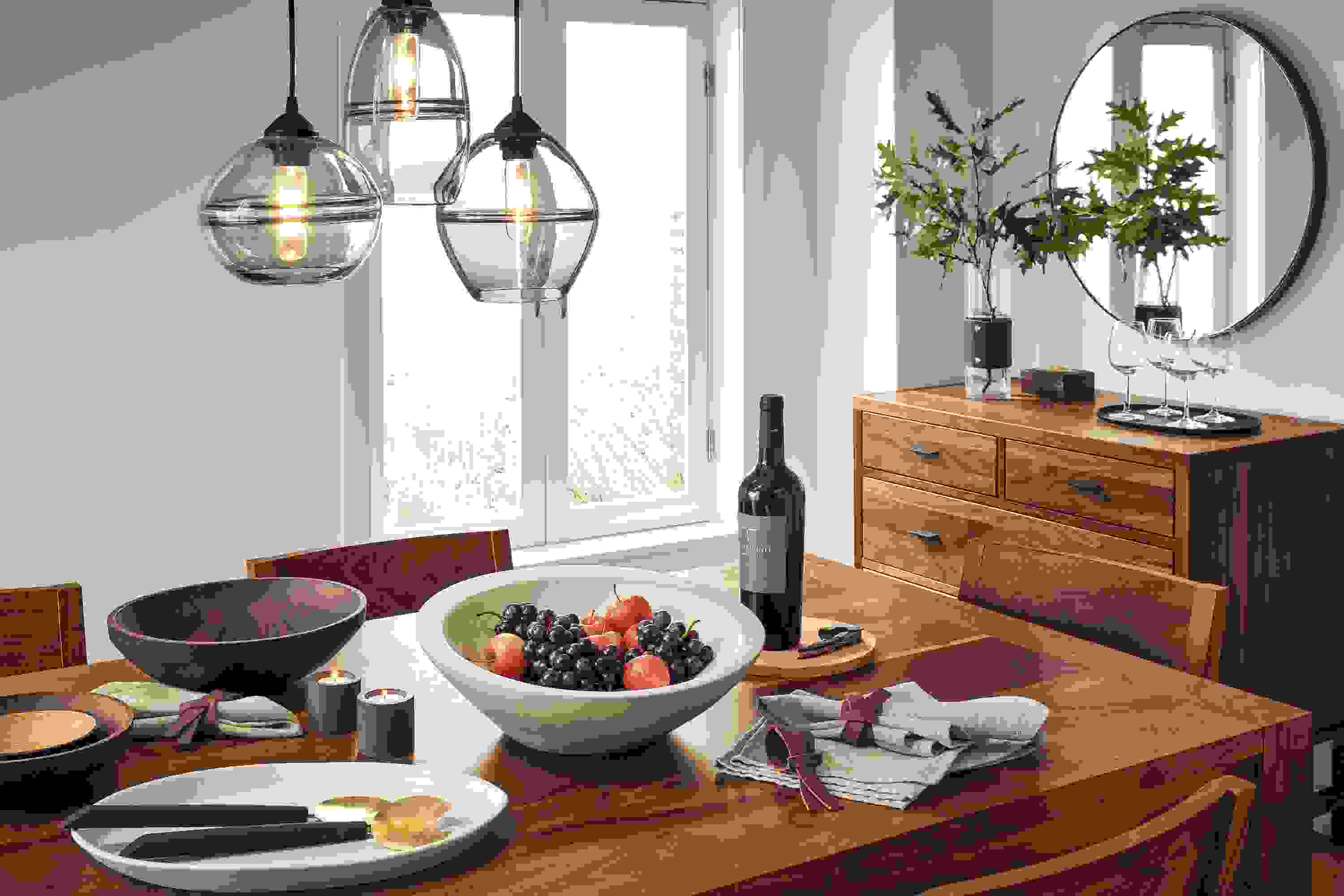 Detail of Walsh table in walnut in dining room with dinner setting.