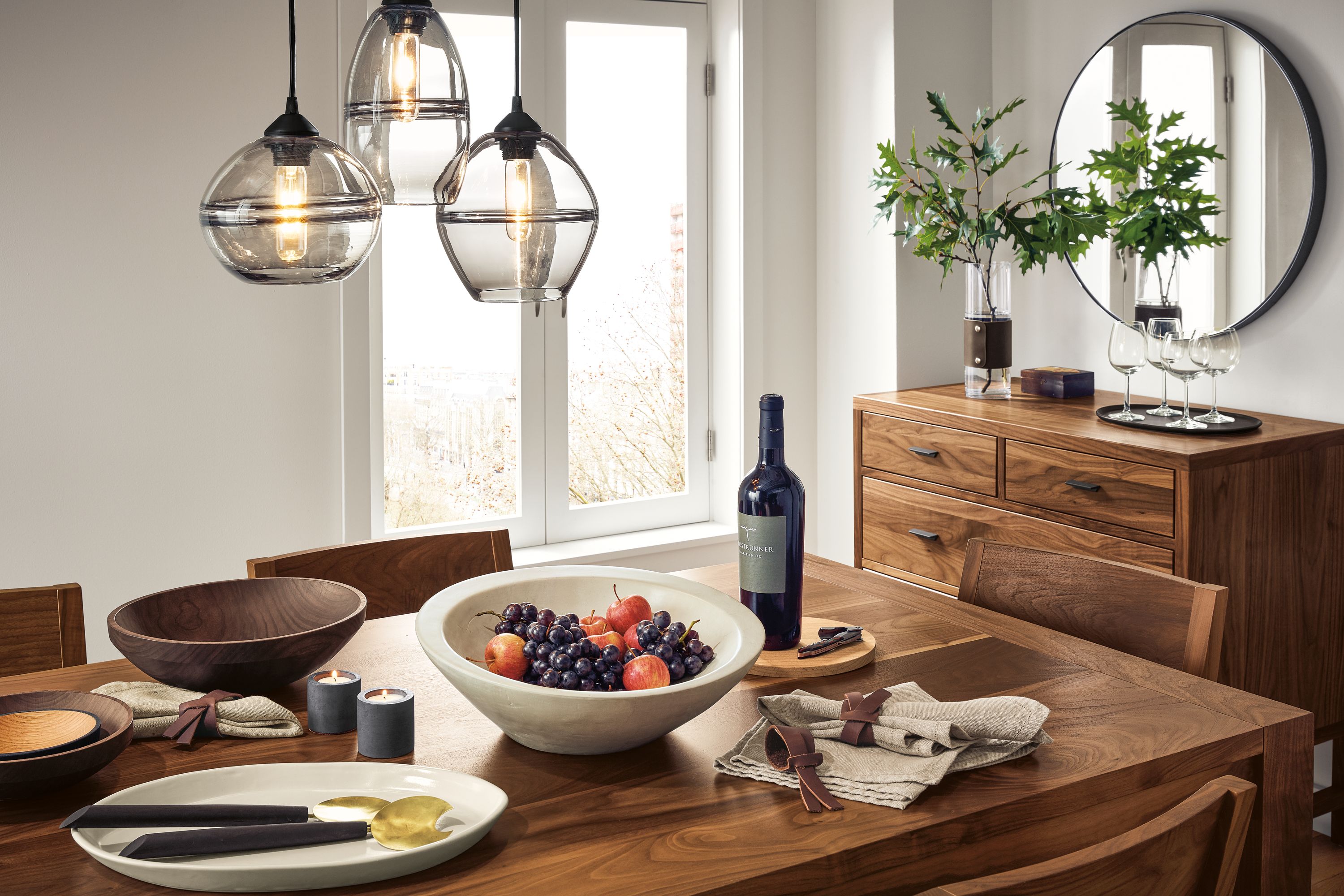 Detail of Walsh table in walnut in dining room with dinner setting.