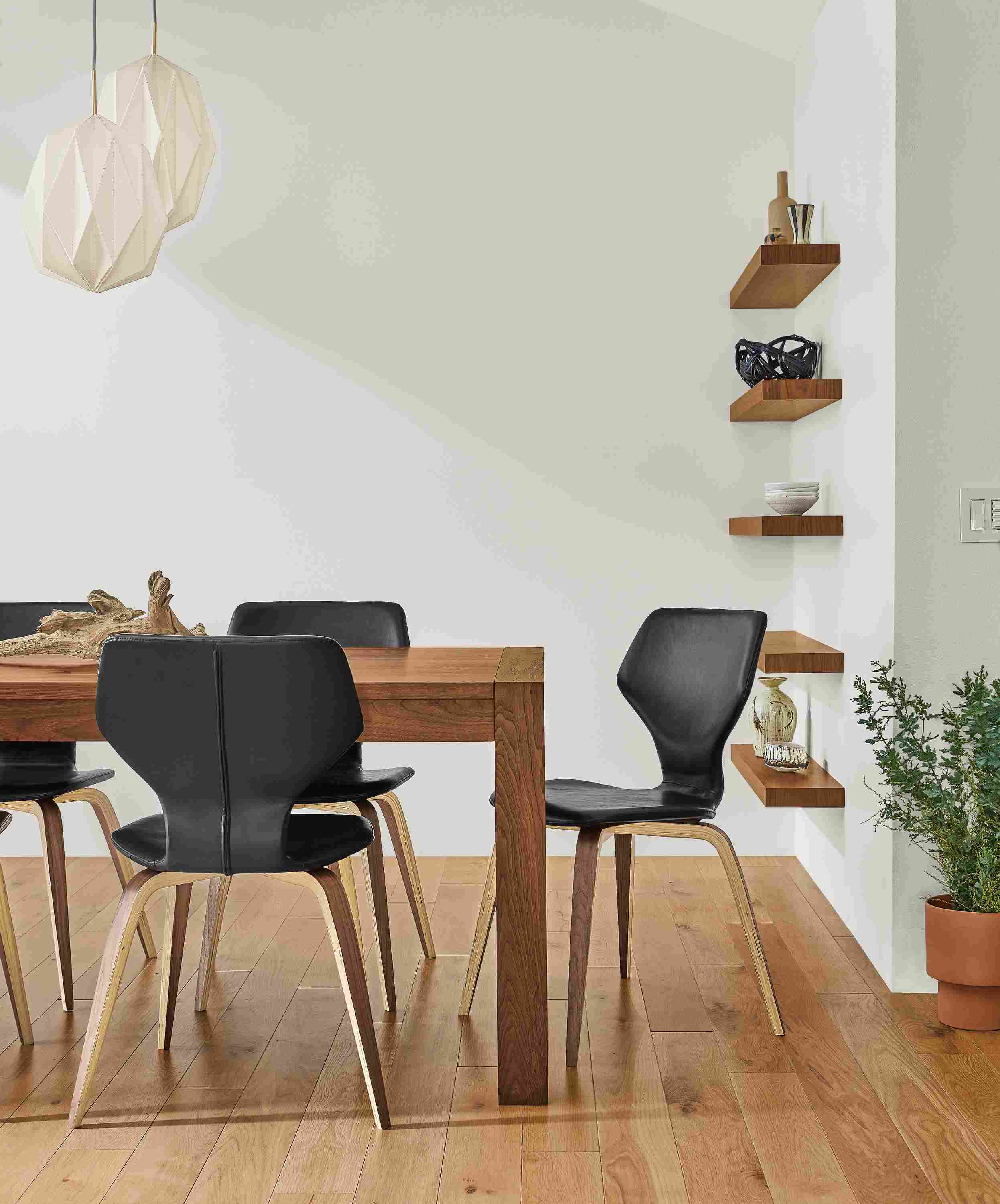Detail of Walsh table in walnut and Pike chairs in graphite Nola leather with walnut legs.