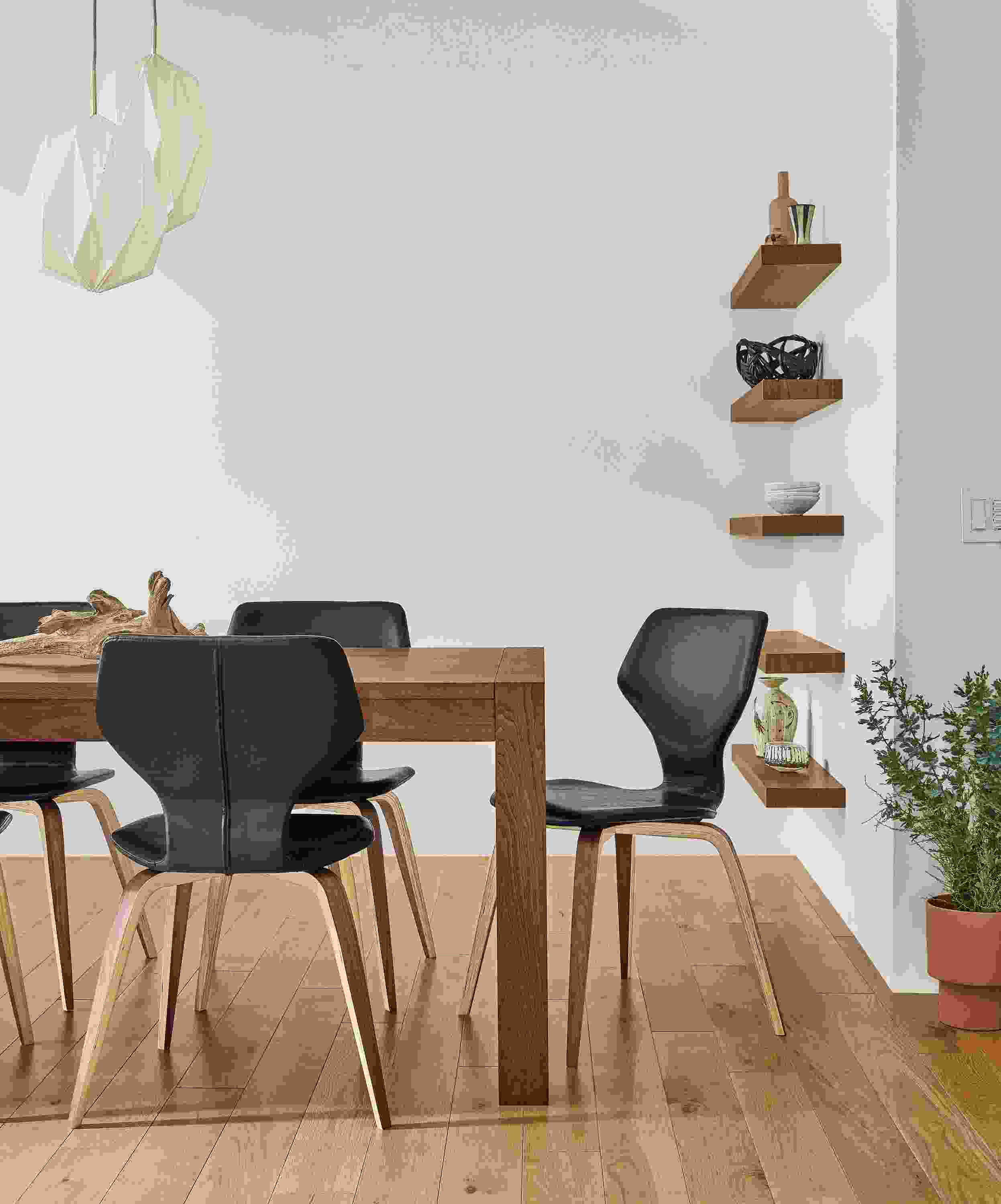 Detail of Walsh table in walnut and Pike chairs in graphite Nola leather with walnut legs.