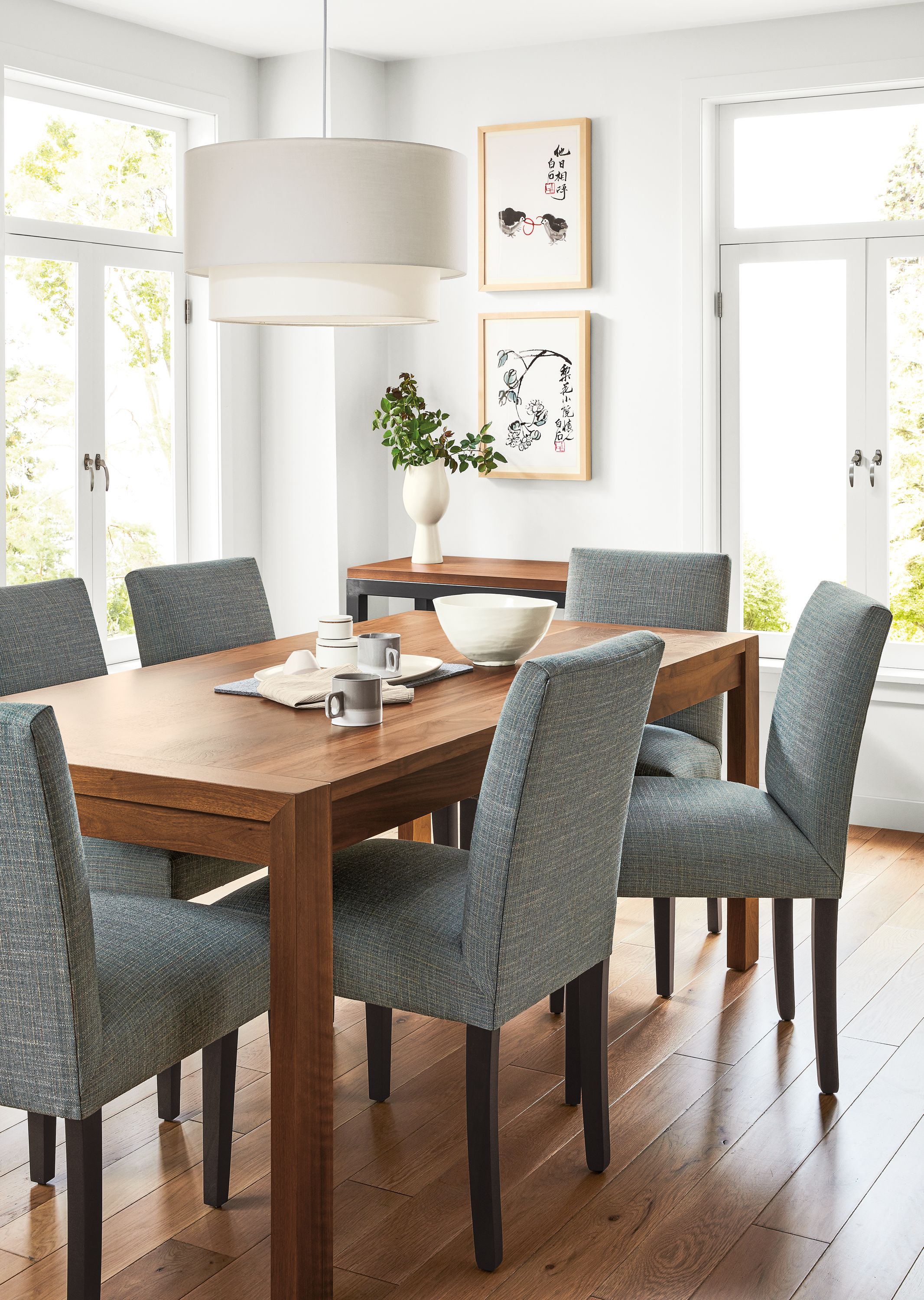 Detail of Walsh table in walnut in dining room with Peyton chairs.