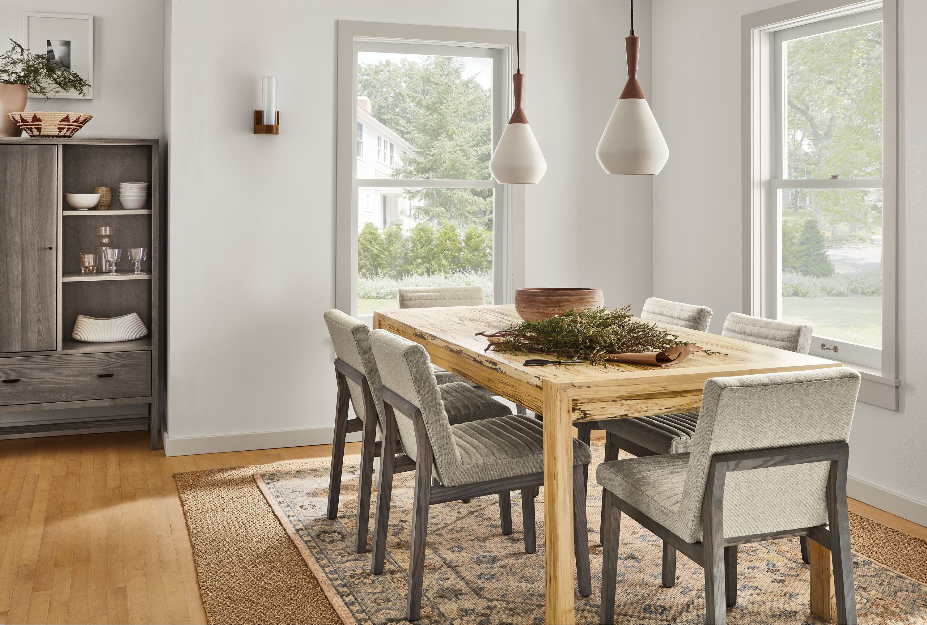 room setting including 72-wide walsh extension dining table, 6 olsen dining chairs, berkeley storage cabinet, essense rug.