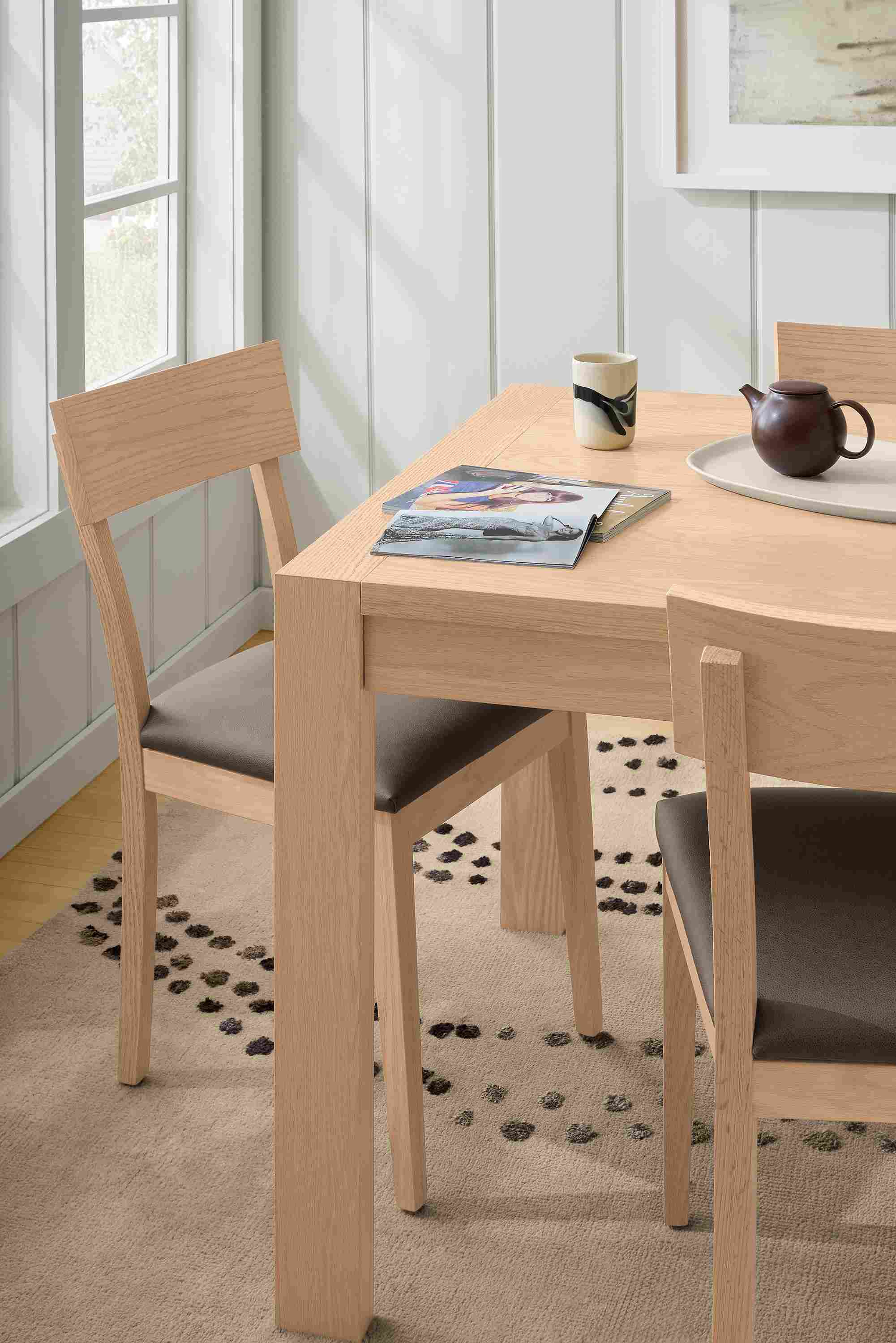 Dining room with detail of Walsh 72-wide dining table in salt on red oak, Doyle side chair in Fiero Mink leather and salt on red oak.