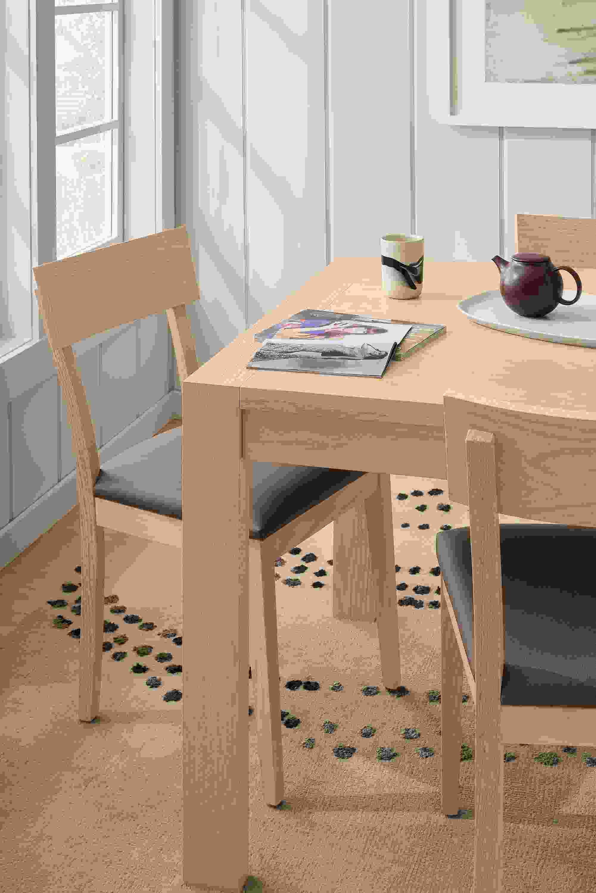 Dining room with detail of Walsh 72-wide dining table in salt on red oak, Doyle side chair in Fiero Mink leather and salt on red oak.