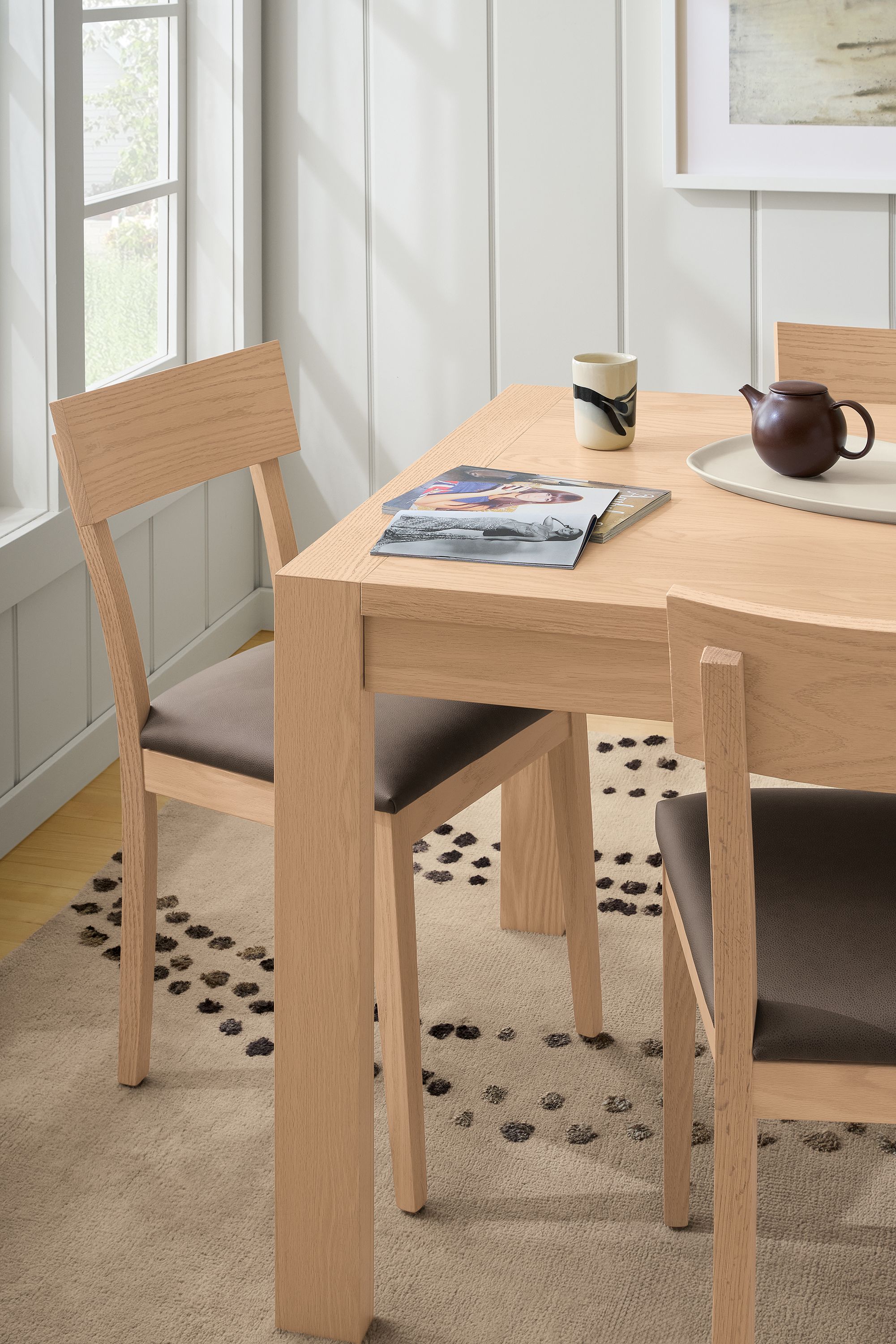 Side chairs in Fiero mink leather and oak with salt stain frame
