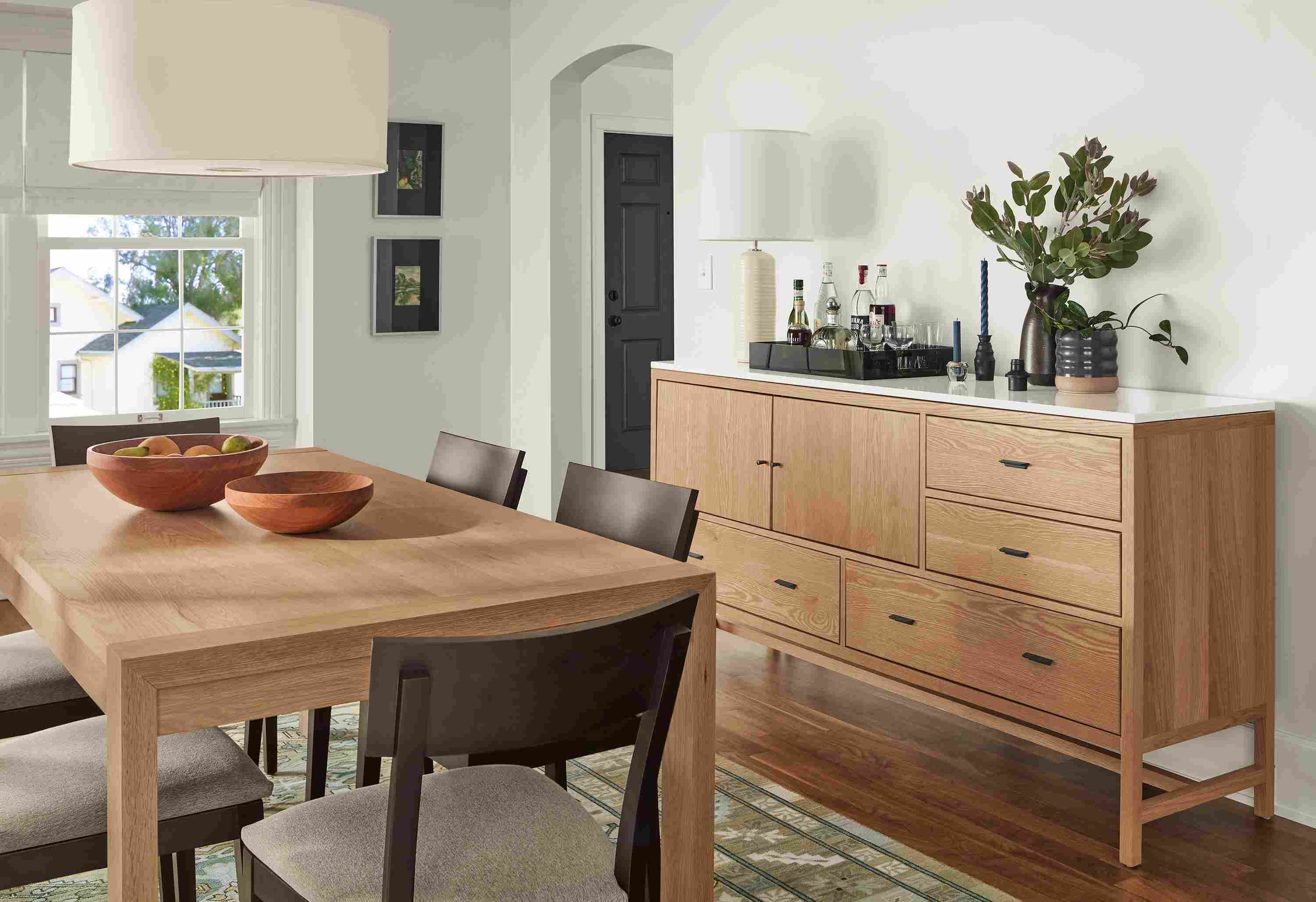 Dining area with Walsh 72-wide dining table and Berkeley 72-wide storage cabinet with quartz top in rye on red oak.