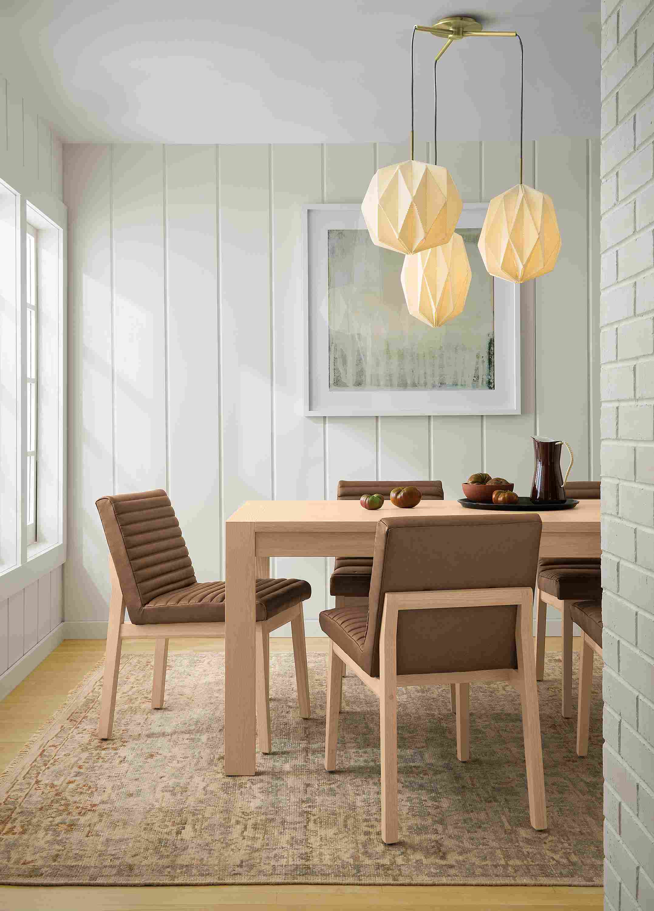 Dining room with Walsh 72-wide table in salt on red oak, Olsen side chair in Fiero Cognac leather and Rosalie rug in frost.