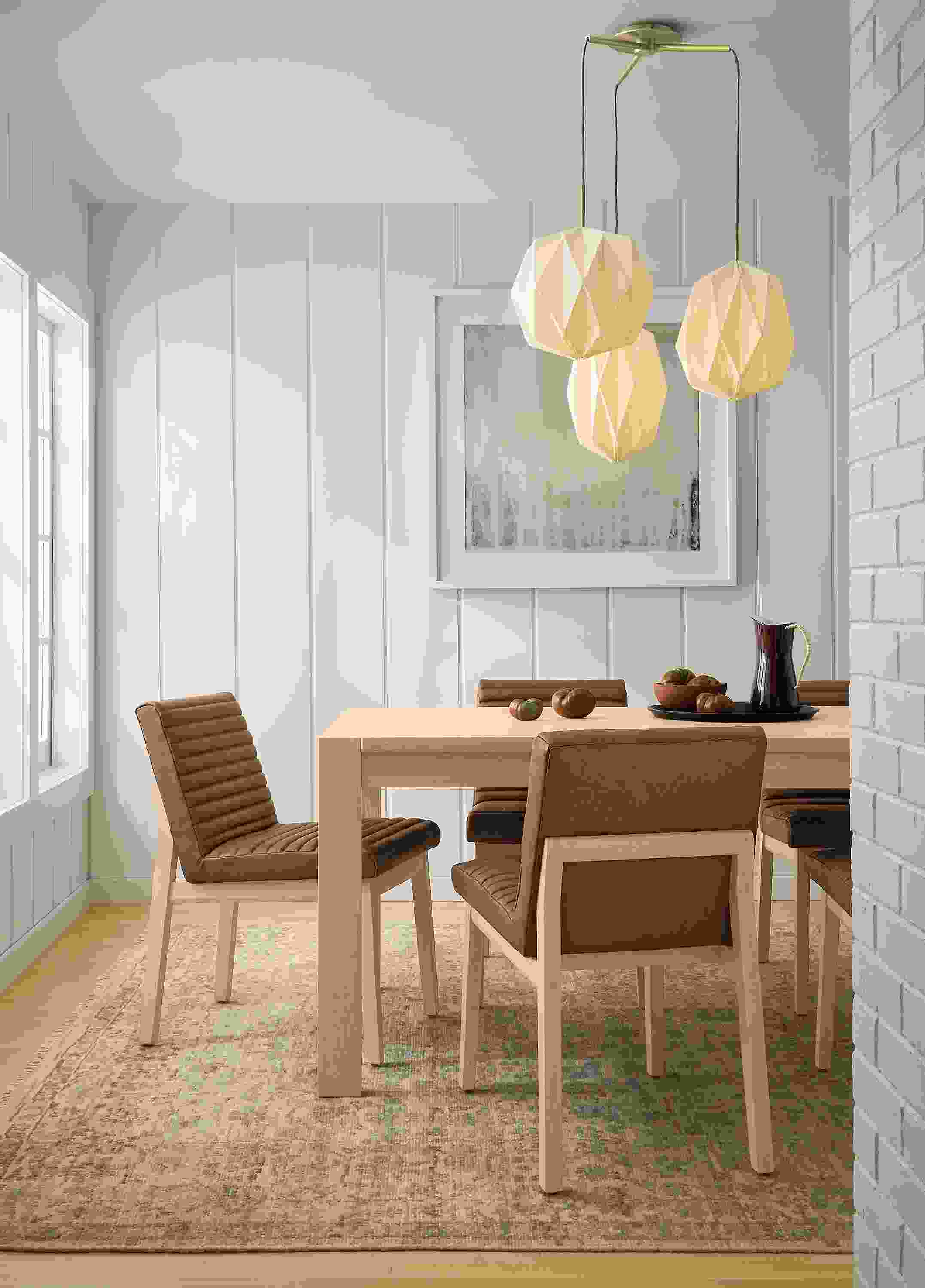 Dining room with Walsh 72-wide table in salt on red oak, Olsen side chair in Fiero Cognac leather and Rosalie rug in frost.