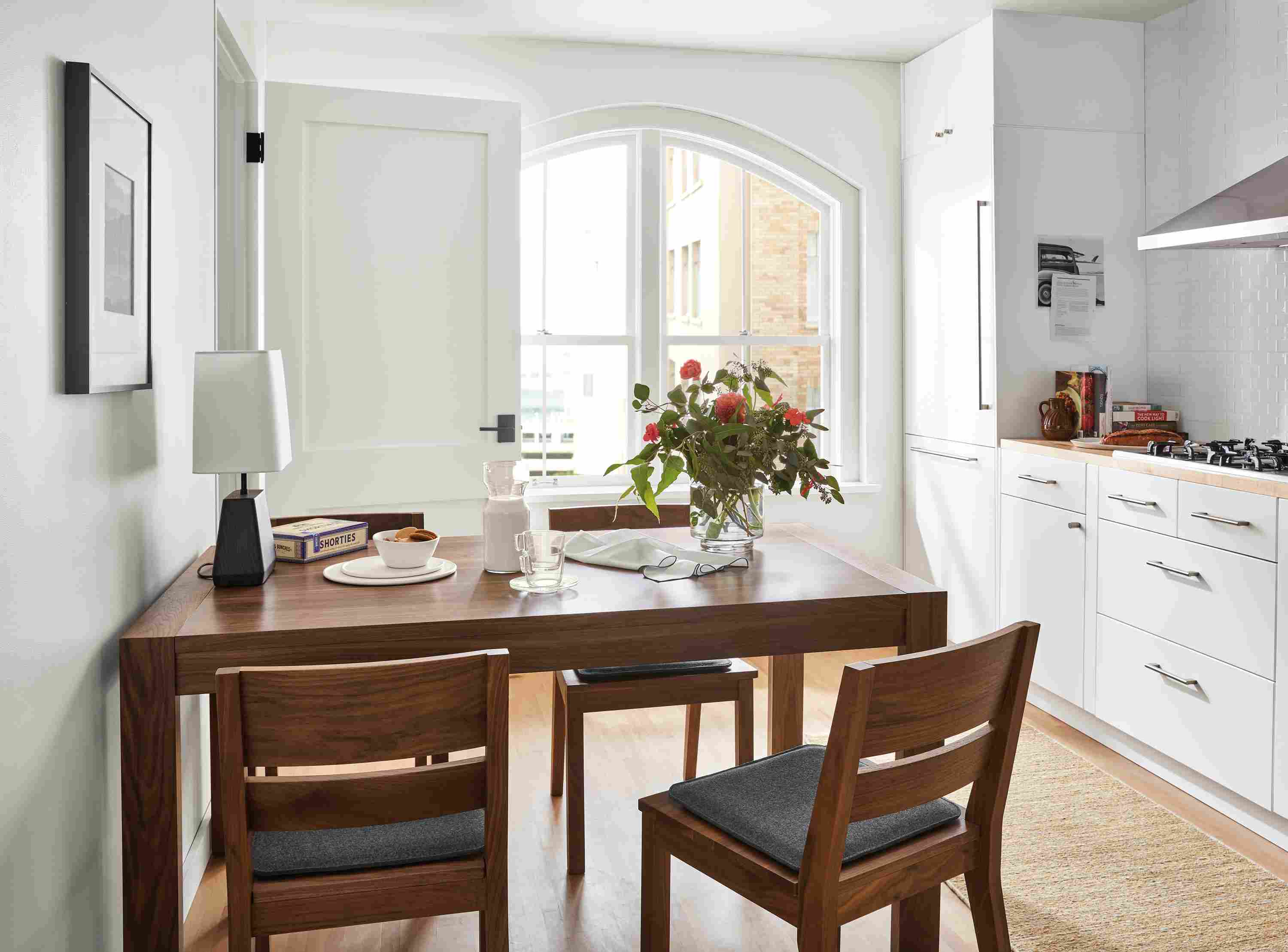 Kitchen with 60-wide Walsh extension dining table, 4 Afton dining chairs with Nina seat cushions and dia rug.
