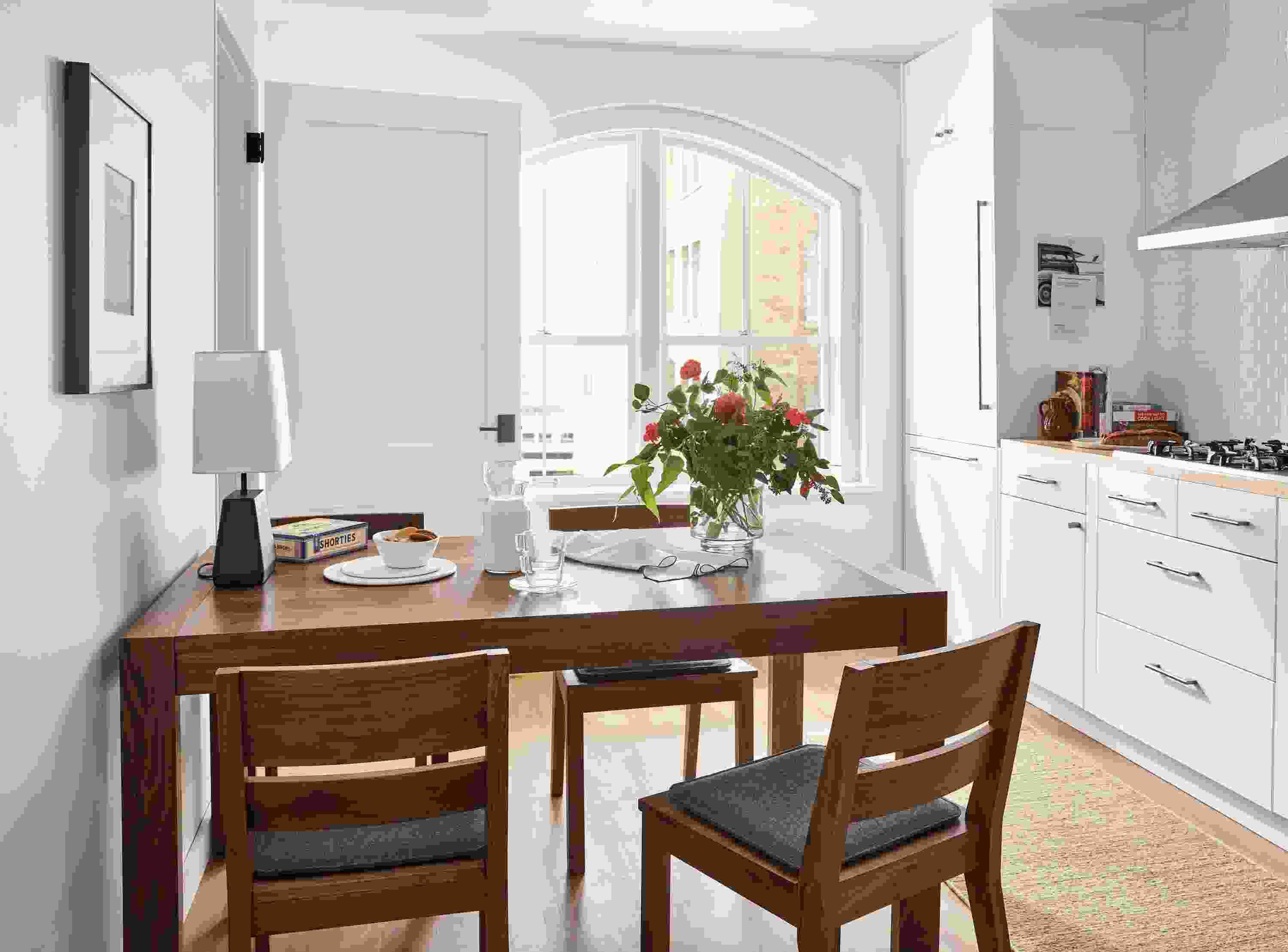Kitchen with 60-wide Walsh extension dining table, 4 Afton dining chairs with Nina seat cushions and dia rug.