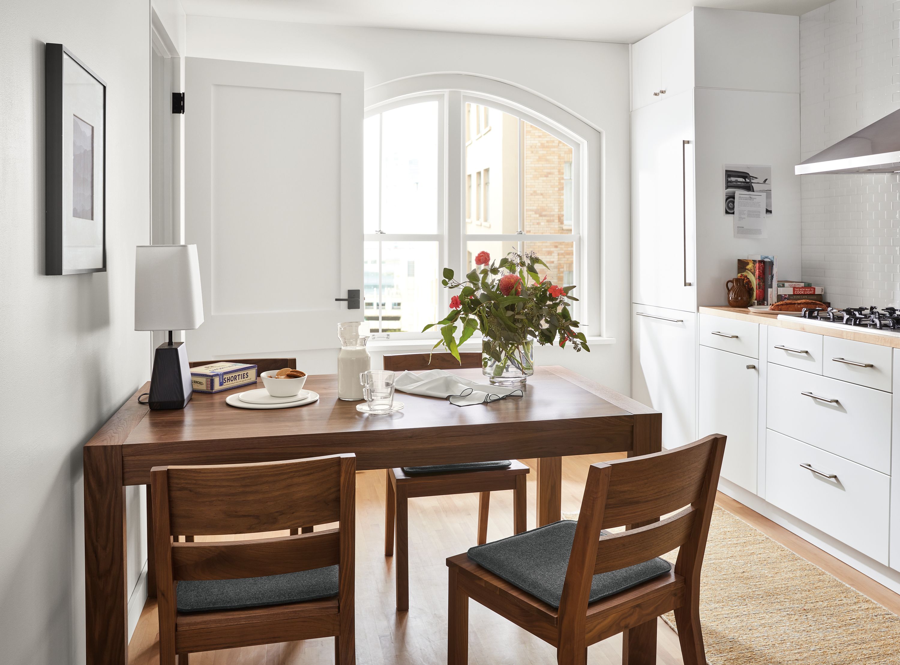 room setting including 60-wide walsh extension dining table, 4 afton dining chairs with nina seat cushions, dia rug.