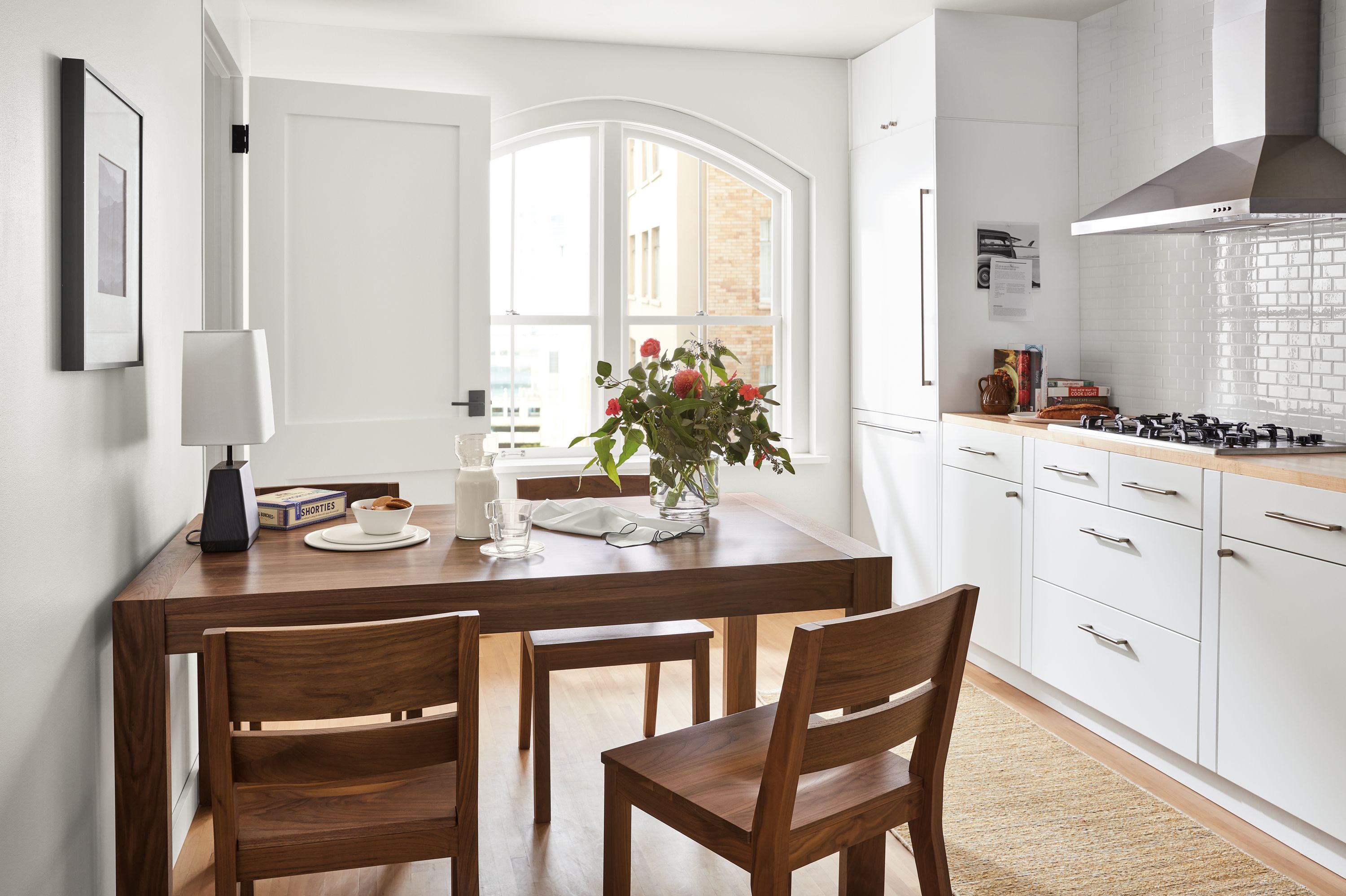 Kitchen with 60-wide Walsh extension dining table, 4 Afton dining chairs and dia rug in wheat.