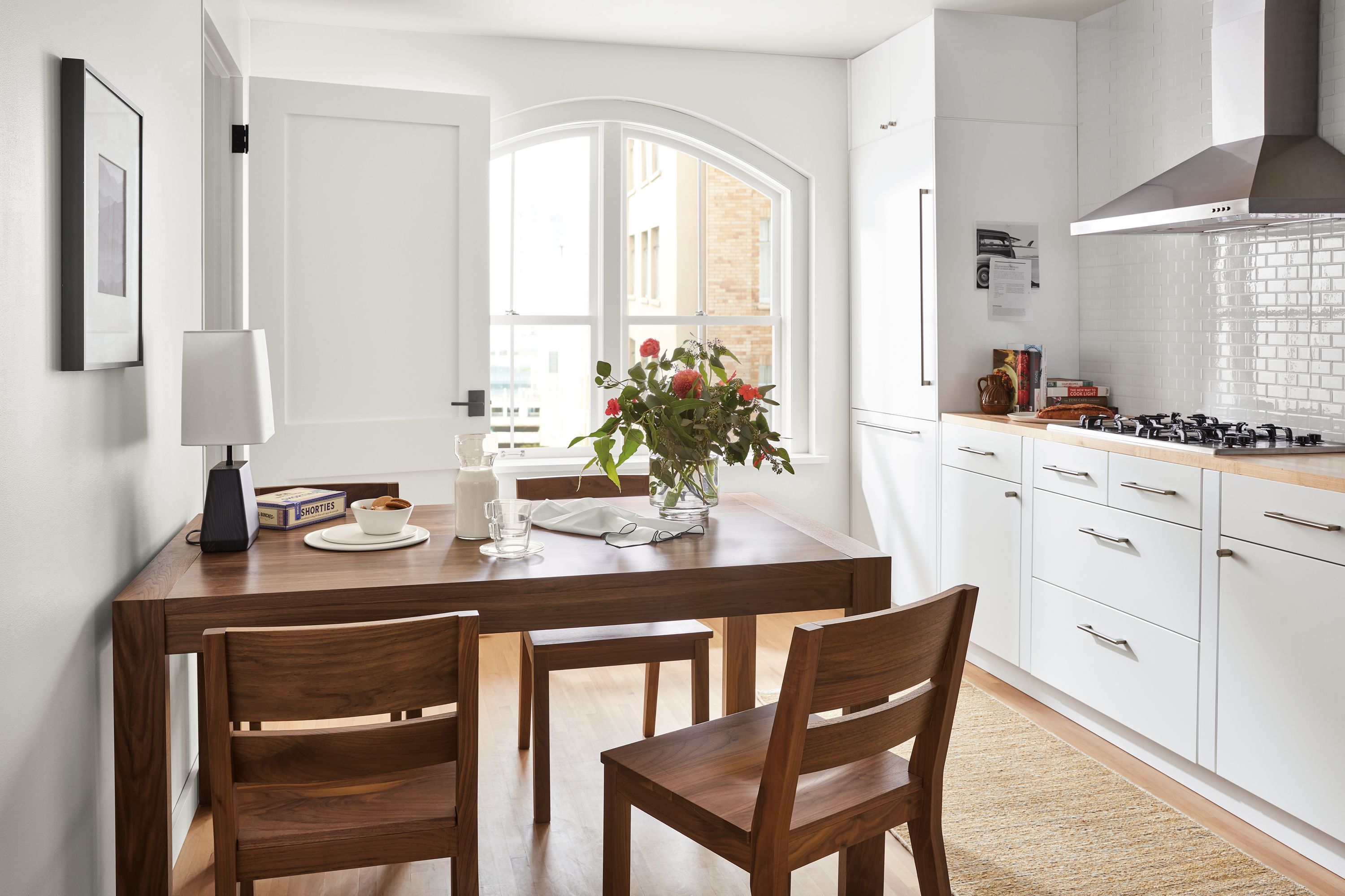 room setting including 60-wide walsh extension dining table, 4 afton dining chairs, dia rug.