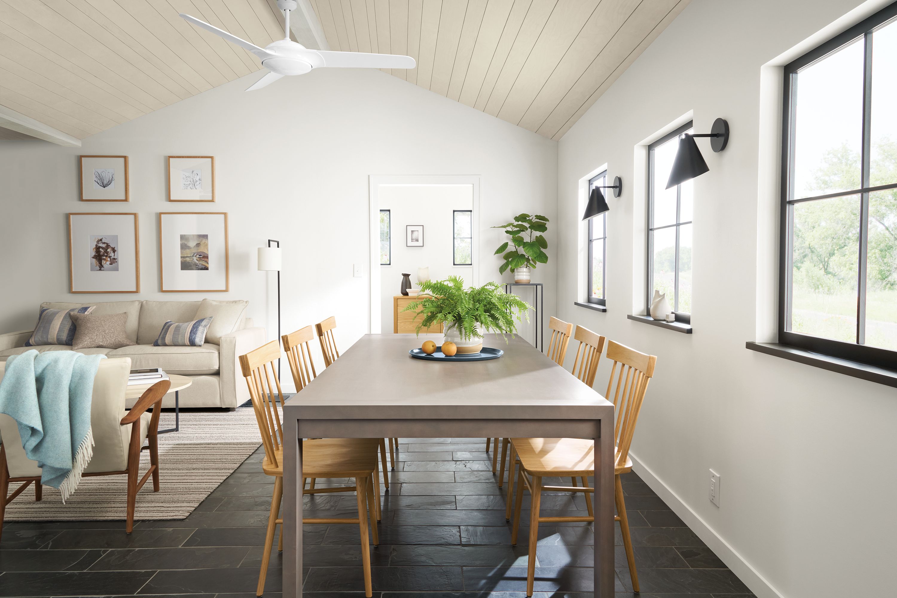 Dining room setting with Walsh 96-inch dining table in shell with Thatcher side chairs in white oak.