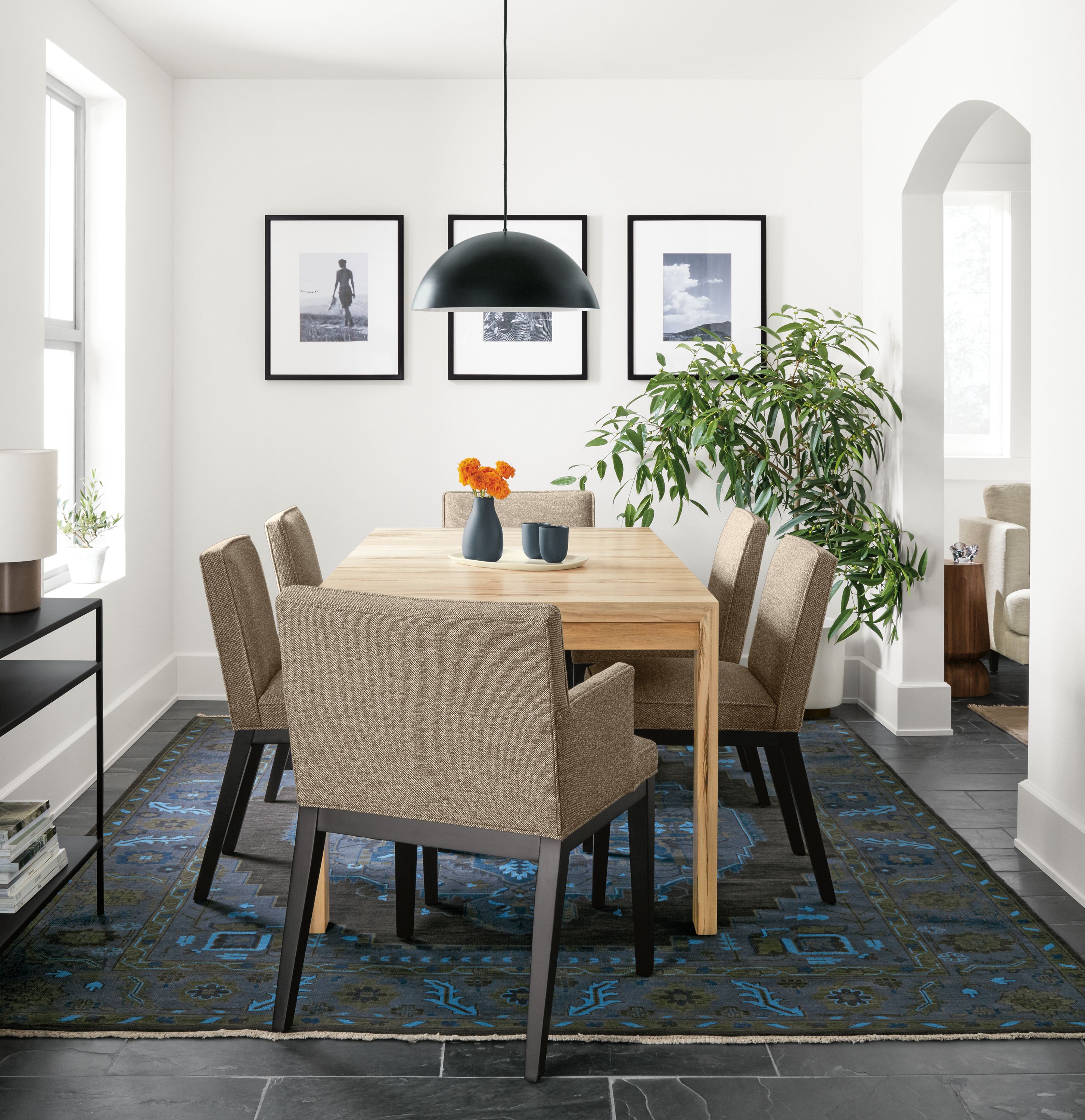 Dining room with Walsh extension table in spalted sugarberry and Ansel chairs in Tatum Gunmetal and Heriz rug.