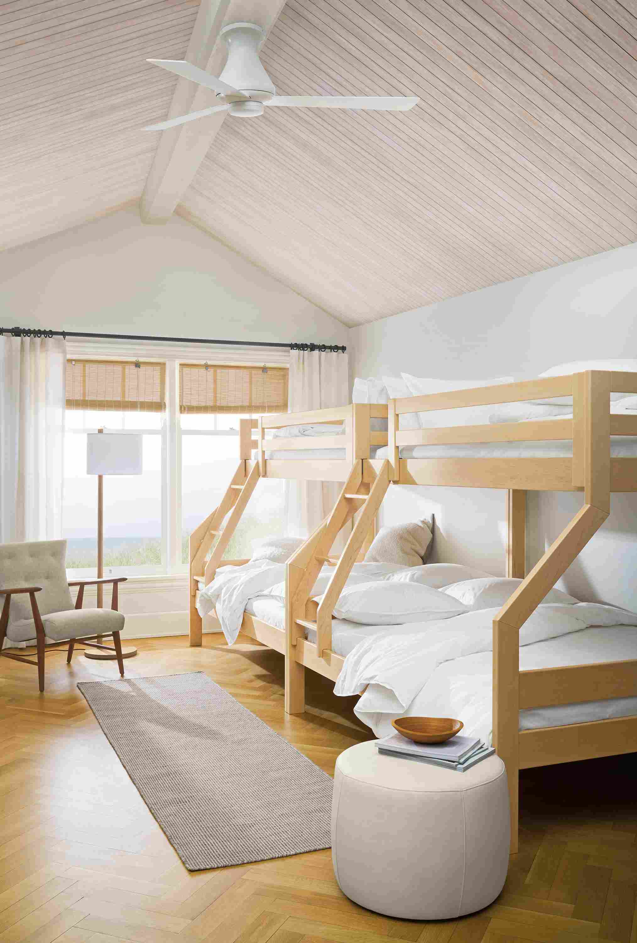 Large bedroom with 2 Waverly twin over full bunk beds in Maple, Selby rug in taupe and Lind ottoman in Laino Bone.