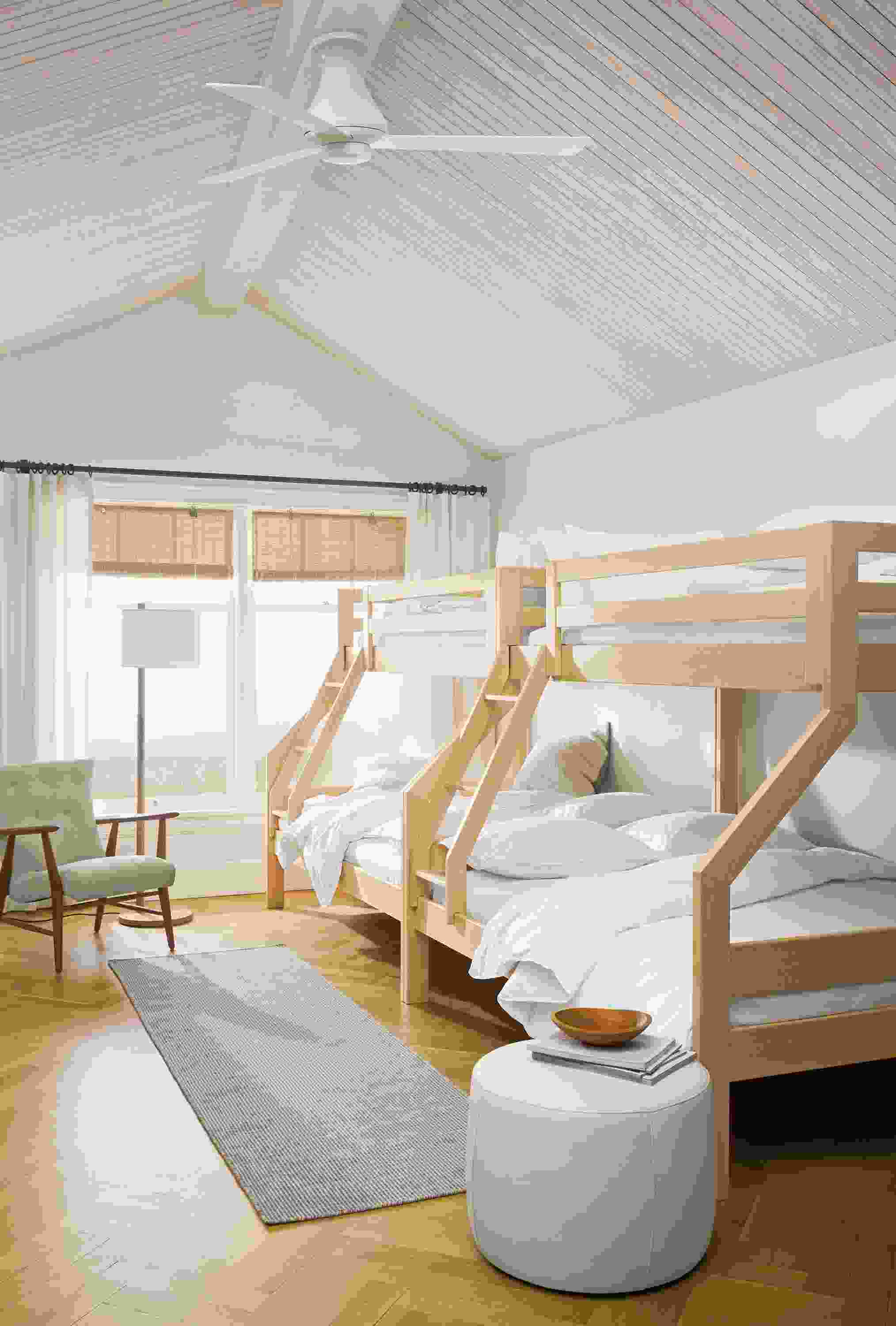 Large bedroom with 2 Waverly twin over full bunk beds in Maple, Selby rug in taupe and Lind ottoman in Laino Bone.