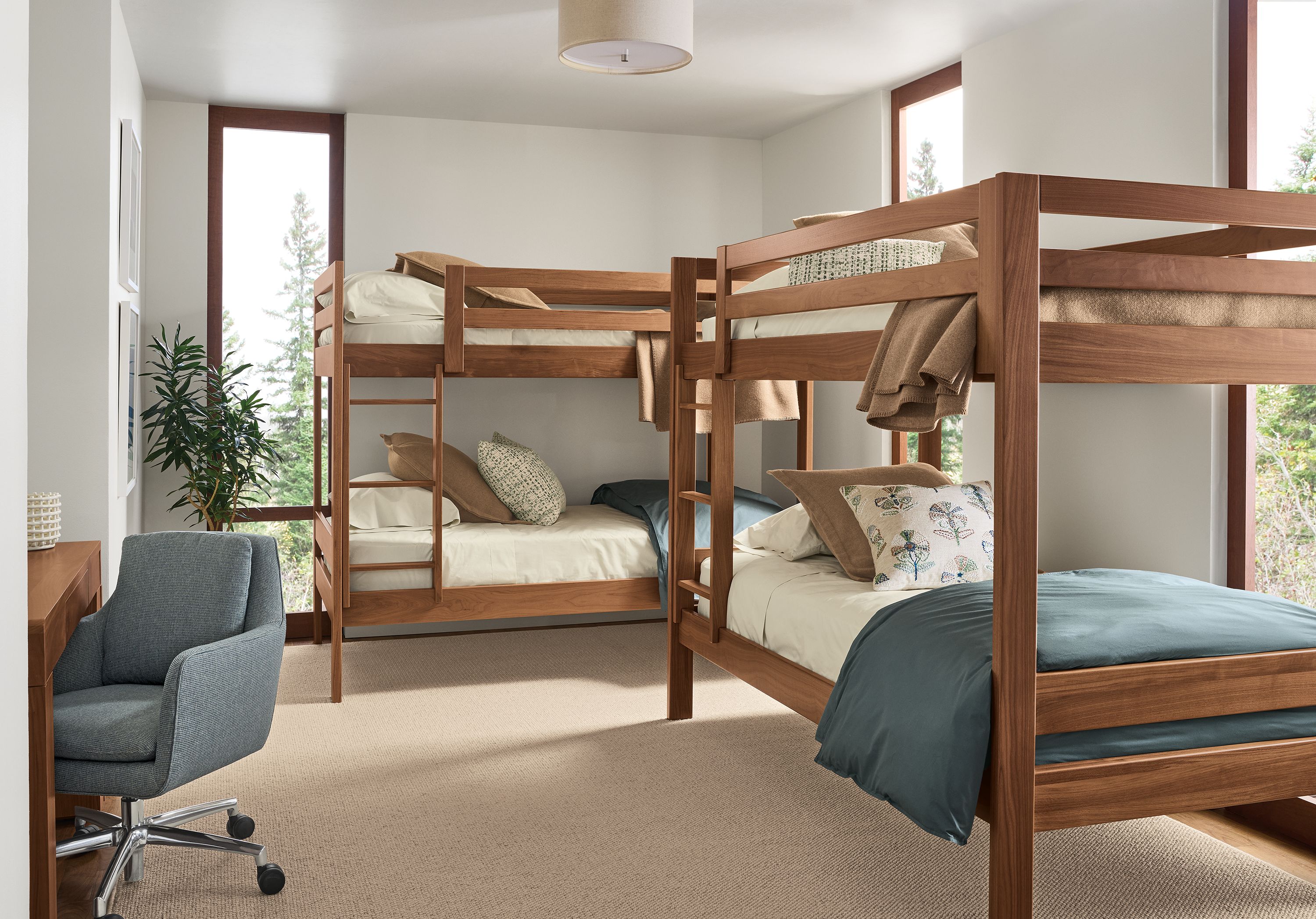 Bedroom with 2 Waverly twin over twin bunk beds in walnut and Flannery 9 by 12 rug in oatmeal.