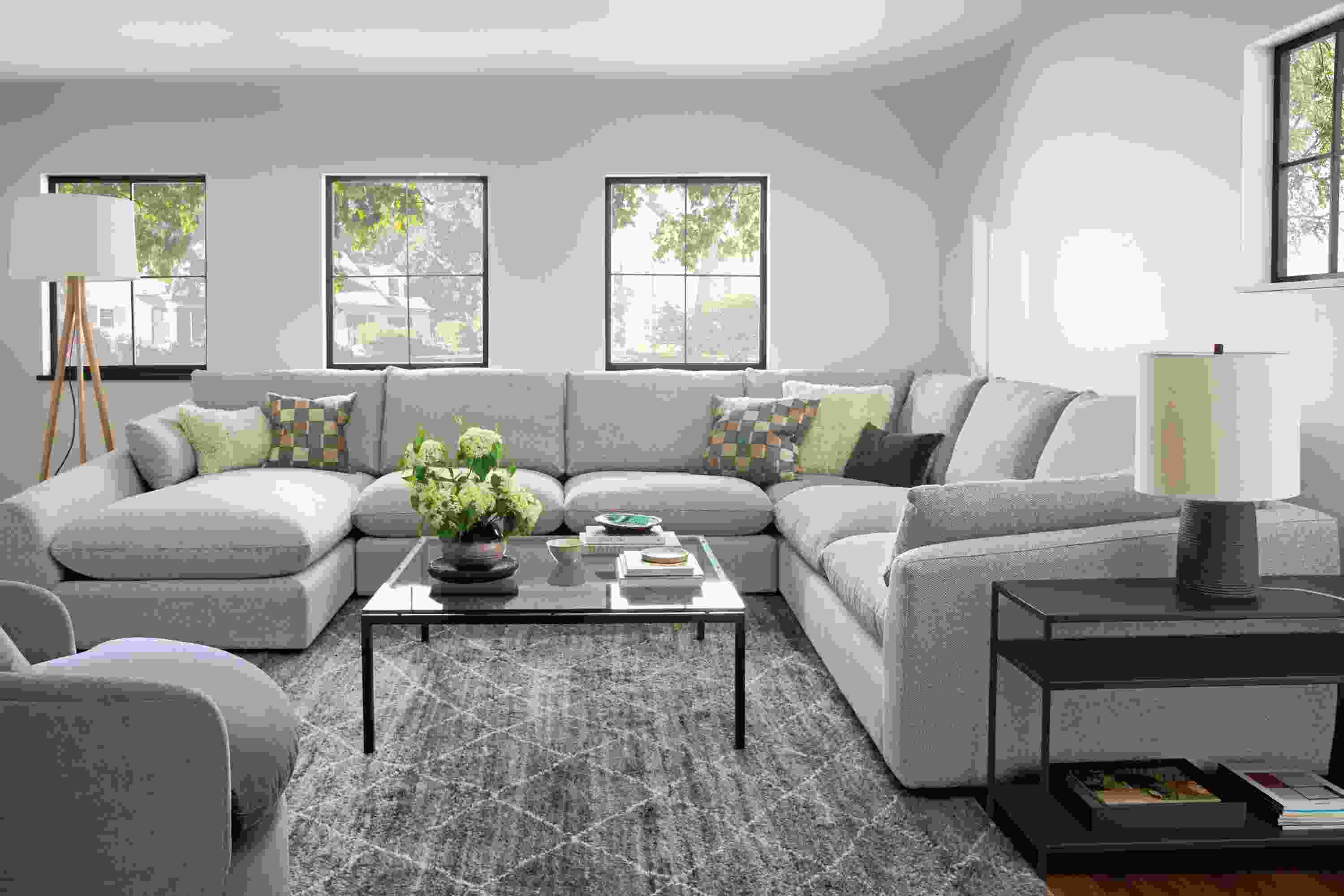 Living room with a Weber 4-piece sectional in Tatum Fabric and a Kalindi rug 8 by 10 rug in charcoal.