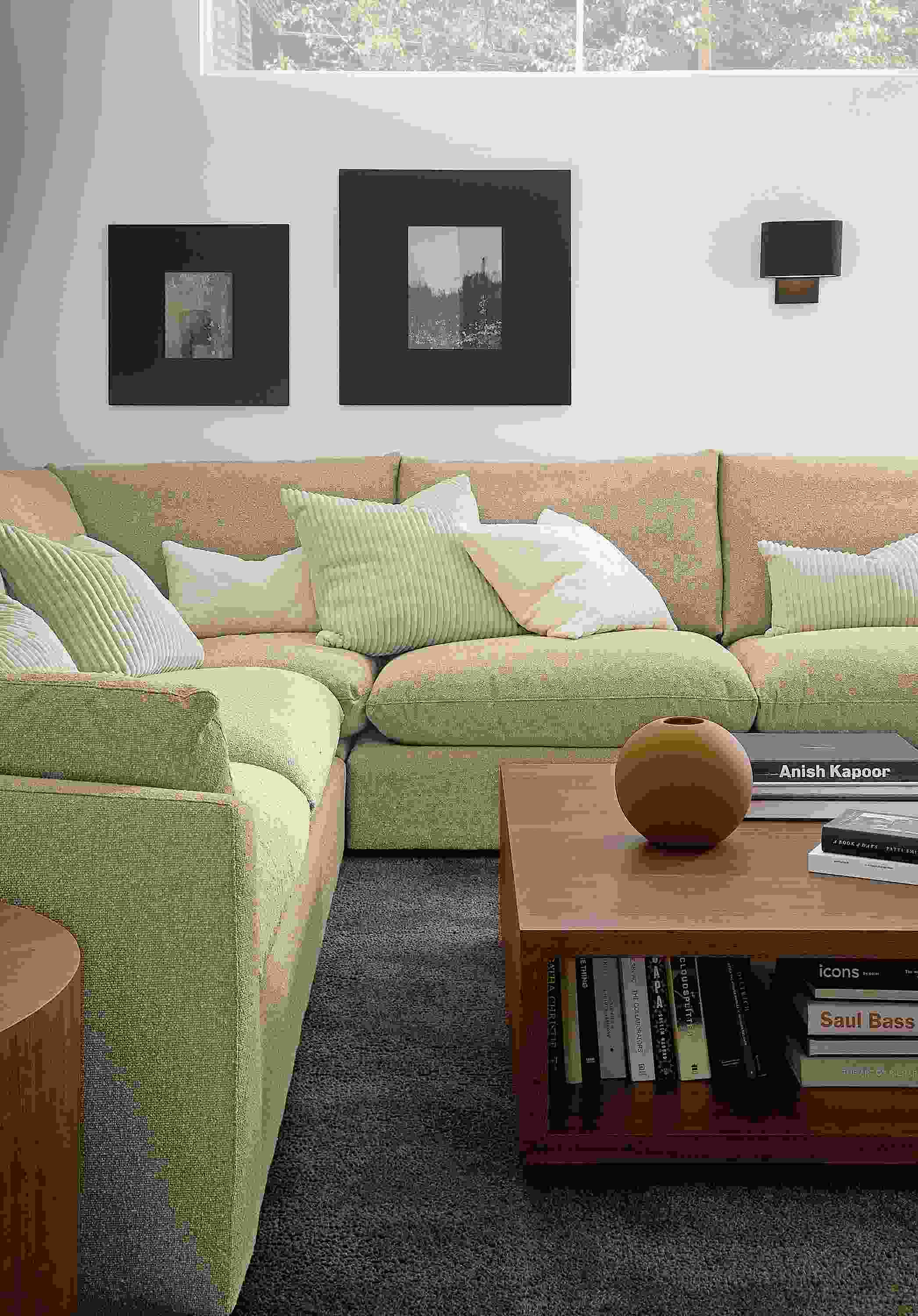 Living room with Weber sectional in Declan Camel, Graham coffee table in walnut and Arden rug in earth.