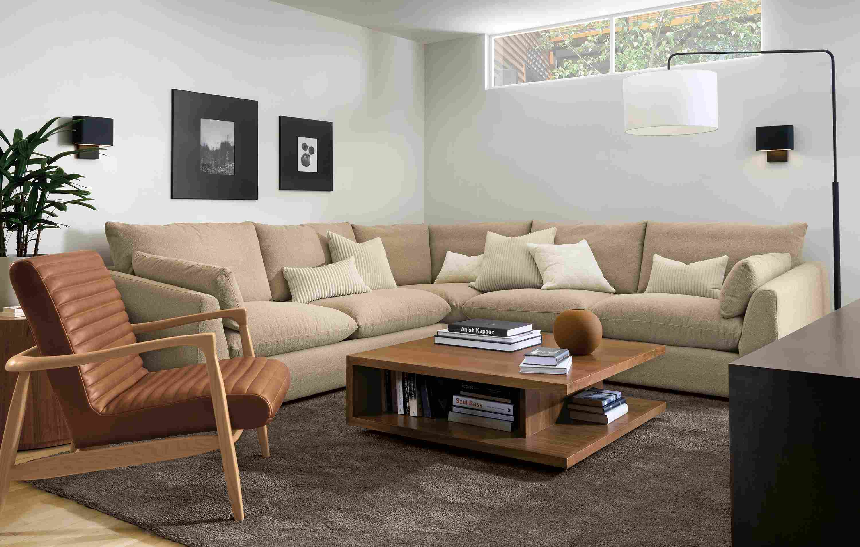 Living room with Weber 120-wide sectional sofa in Declan Camel and Callan chair in Sarto Cognac Leather.