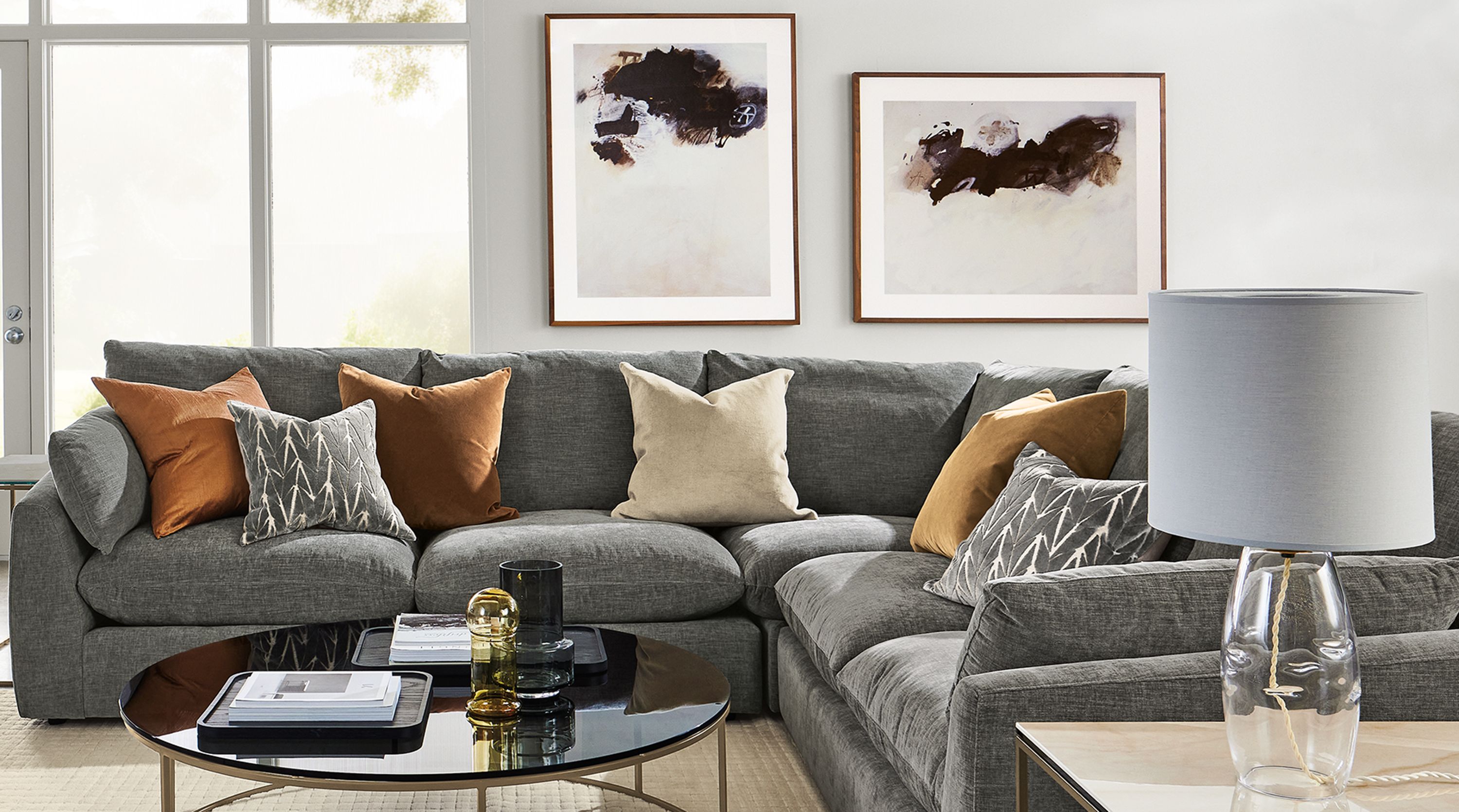Living roon with weber sectional in mori graphite fabric, aidan chair, type coffee and end tables and hensley media cabinet.