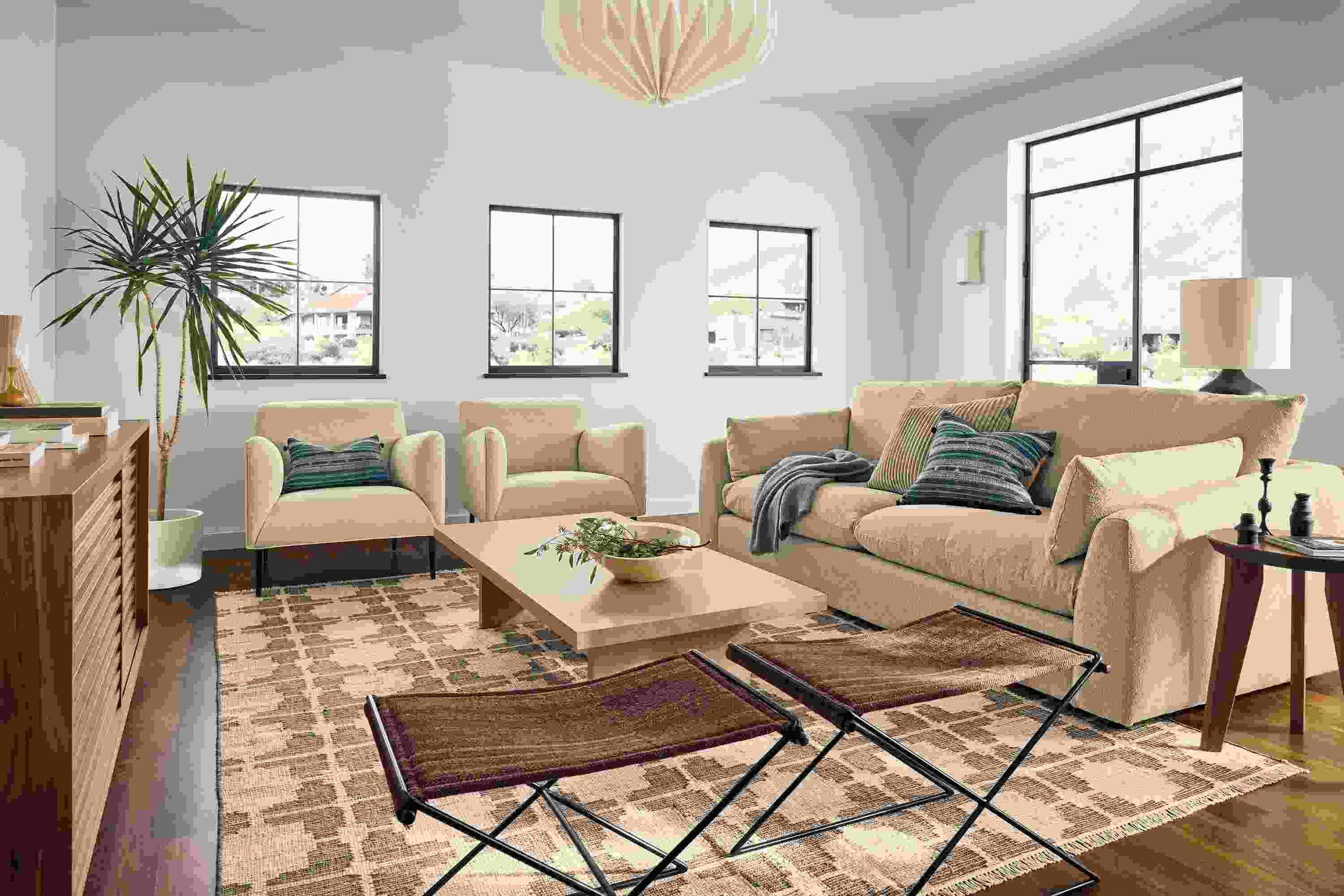 Living room with Weber 96-wide sofa in Declan Camel, 2 Matteo chairs in Tatum Natural and Tinsley rug in putty.