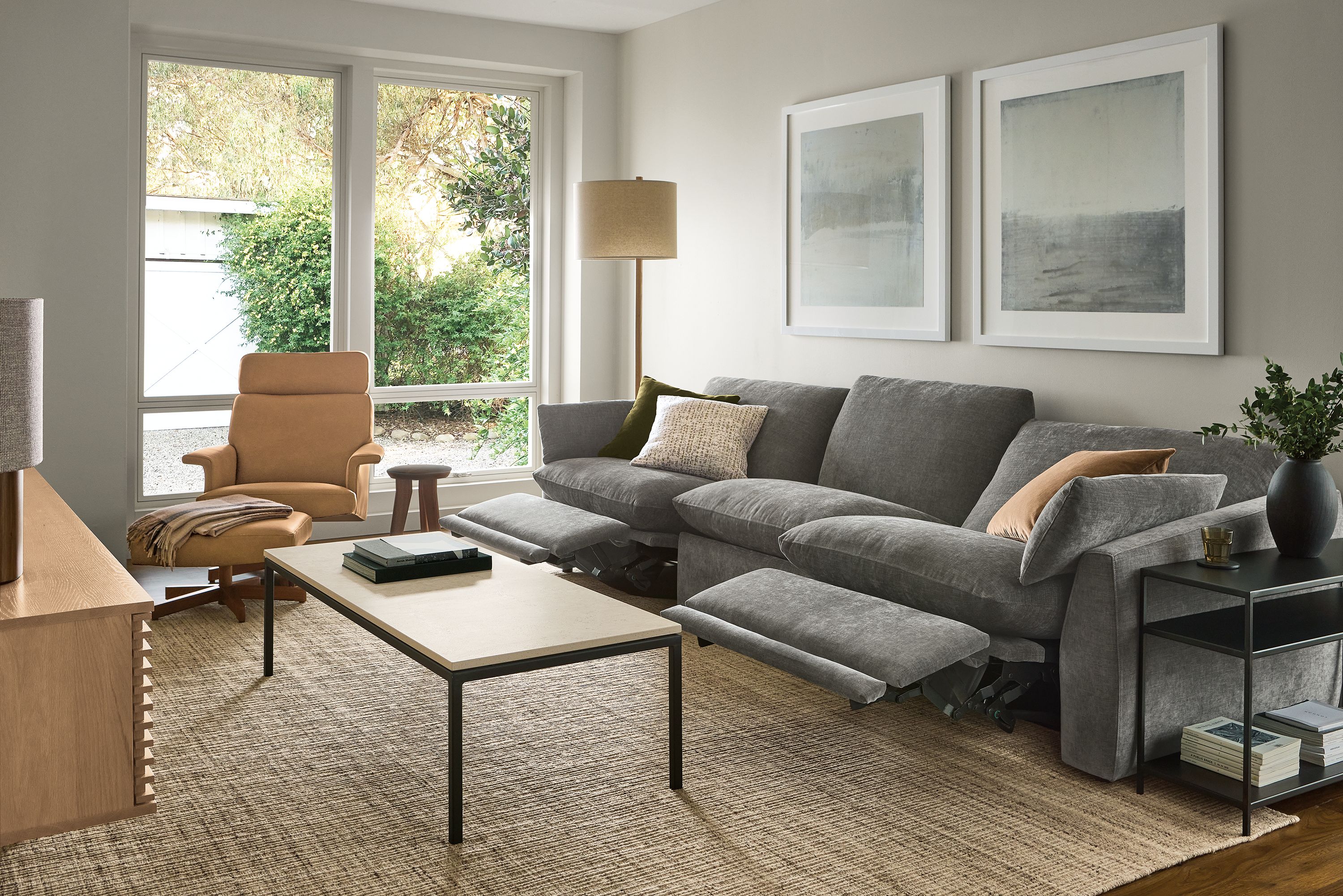 Living room with Weber sofa with 2-piece power recliners in Mori Graphite shown reclined with footrests extended.