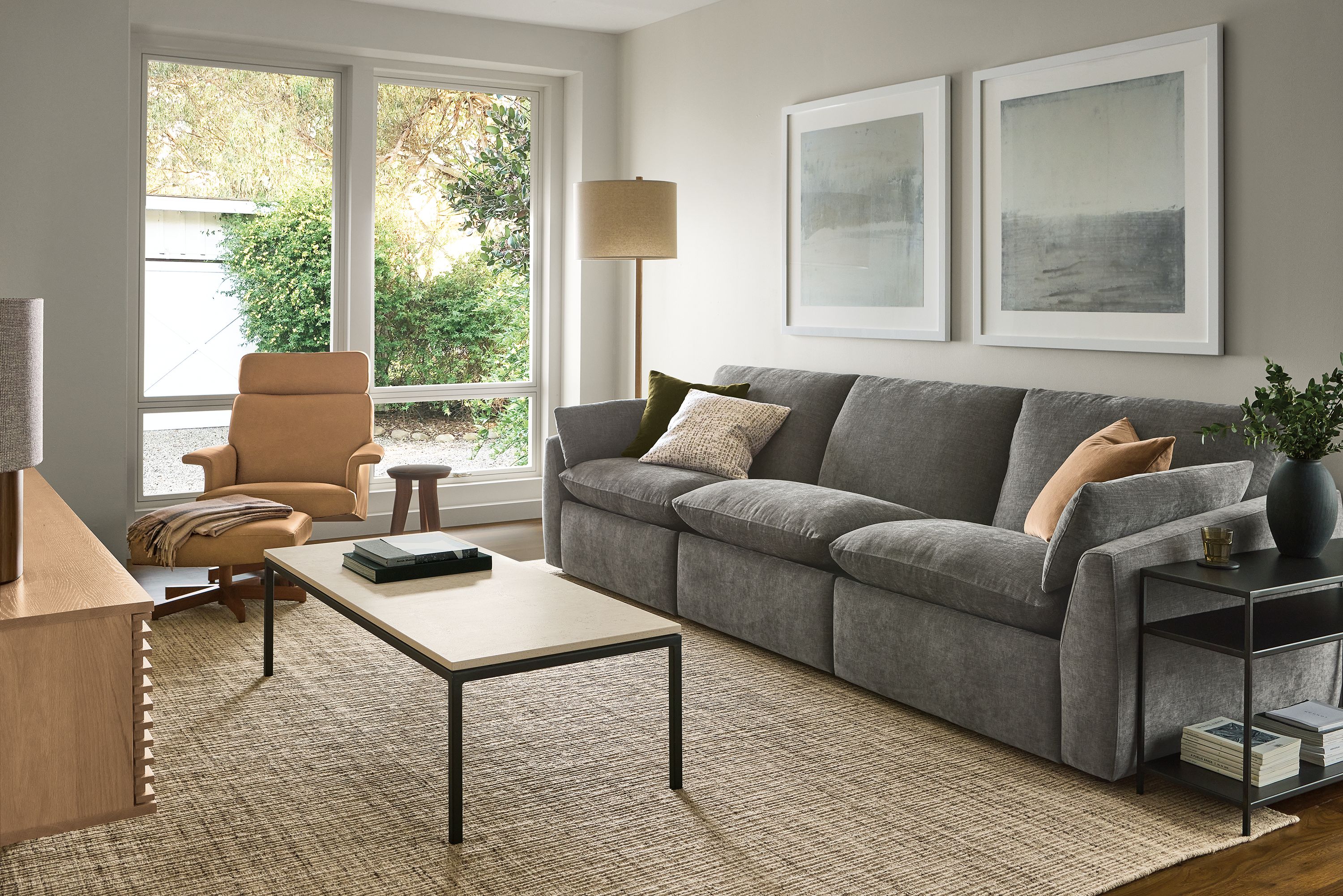 Living room with Weber 124-wide sofa with 2-piece power recliner in Mori Graphite and Artis rug in stone.