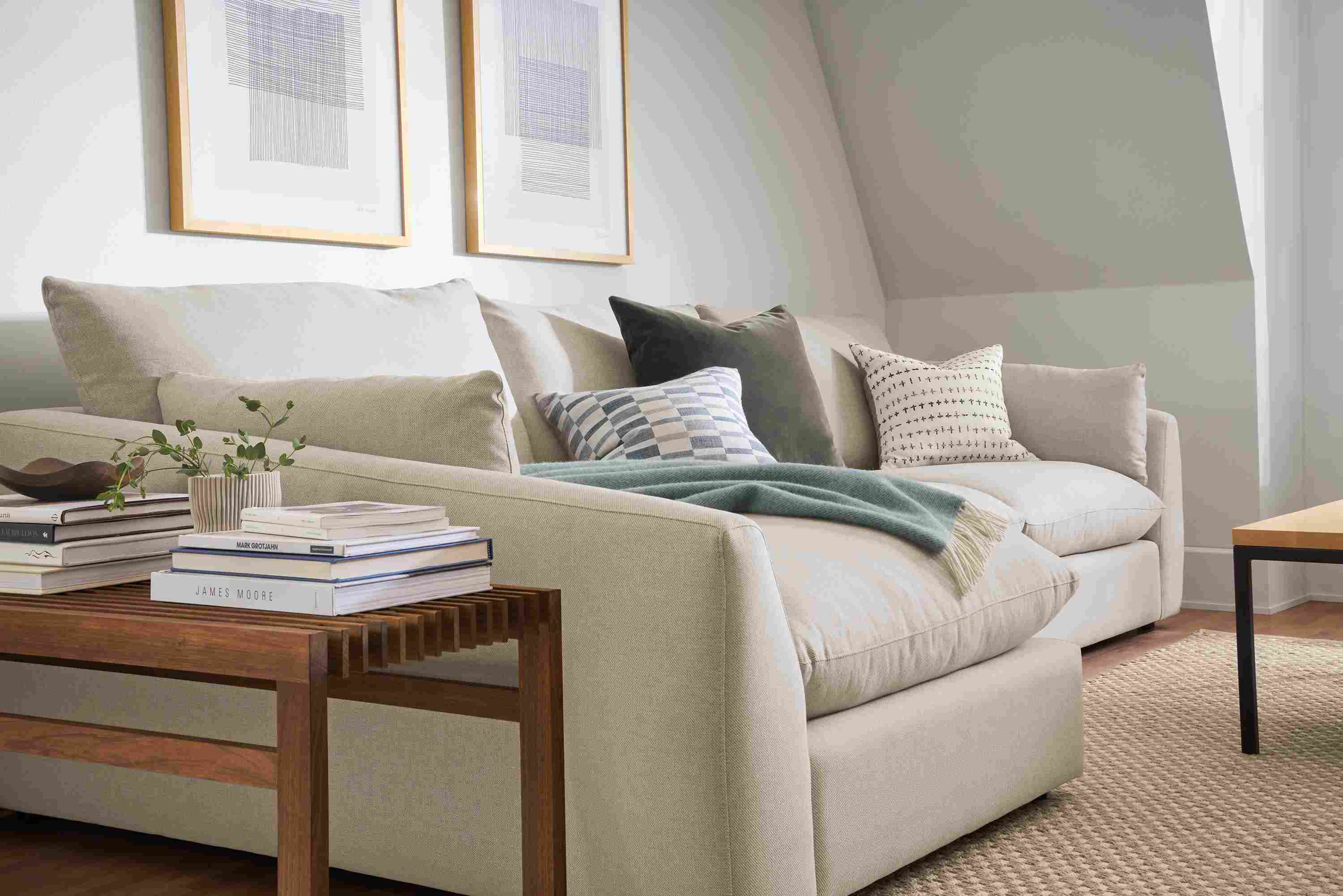 Weber sofa with chaise in Gino Oatmeal in living room with Ewing bench in walnut.