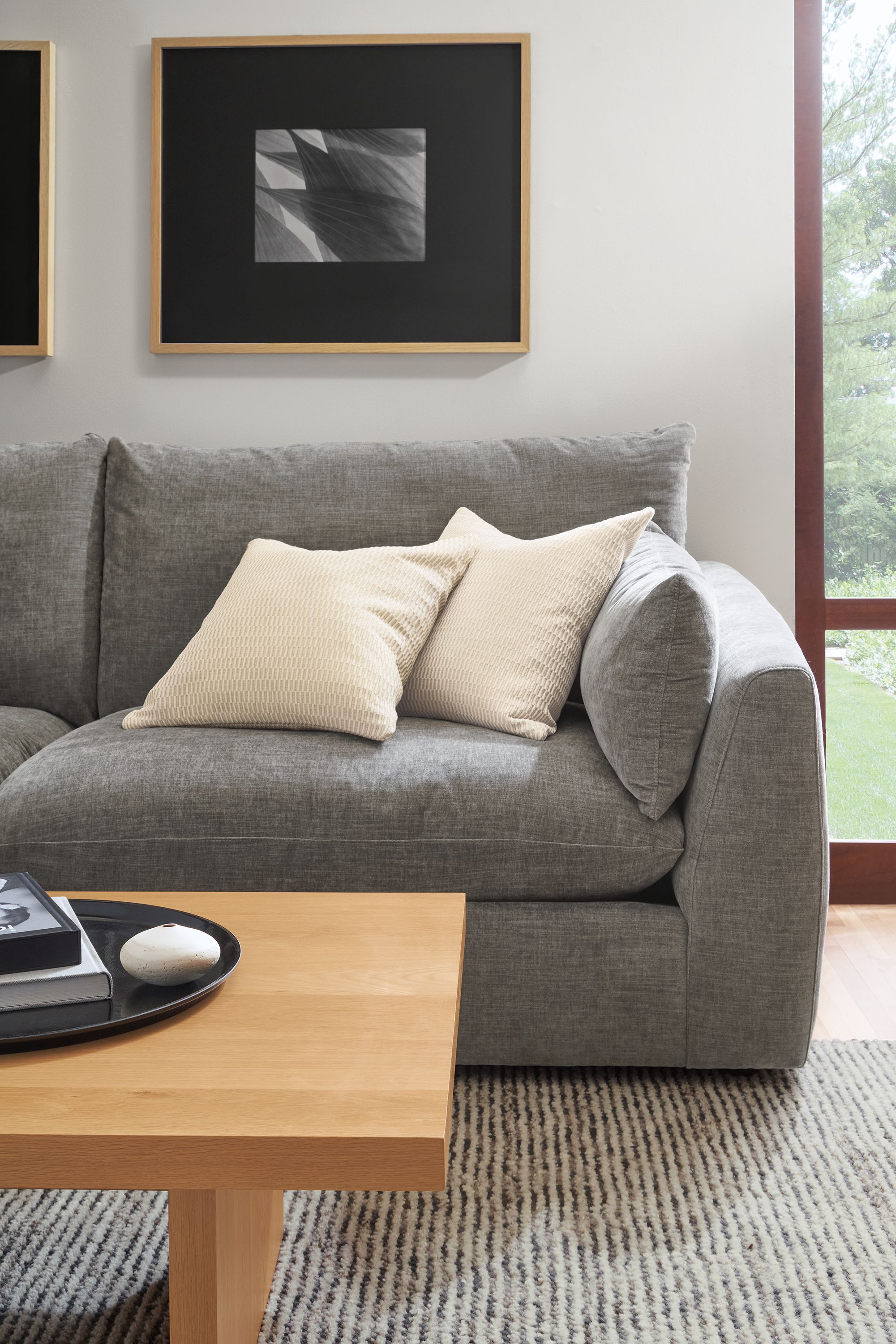 detail of weber sofa in mori graphite fabric with montreal throw pillows in ivory.