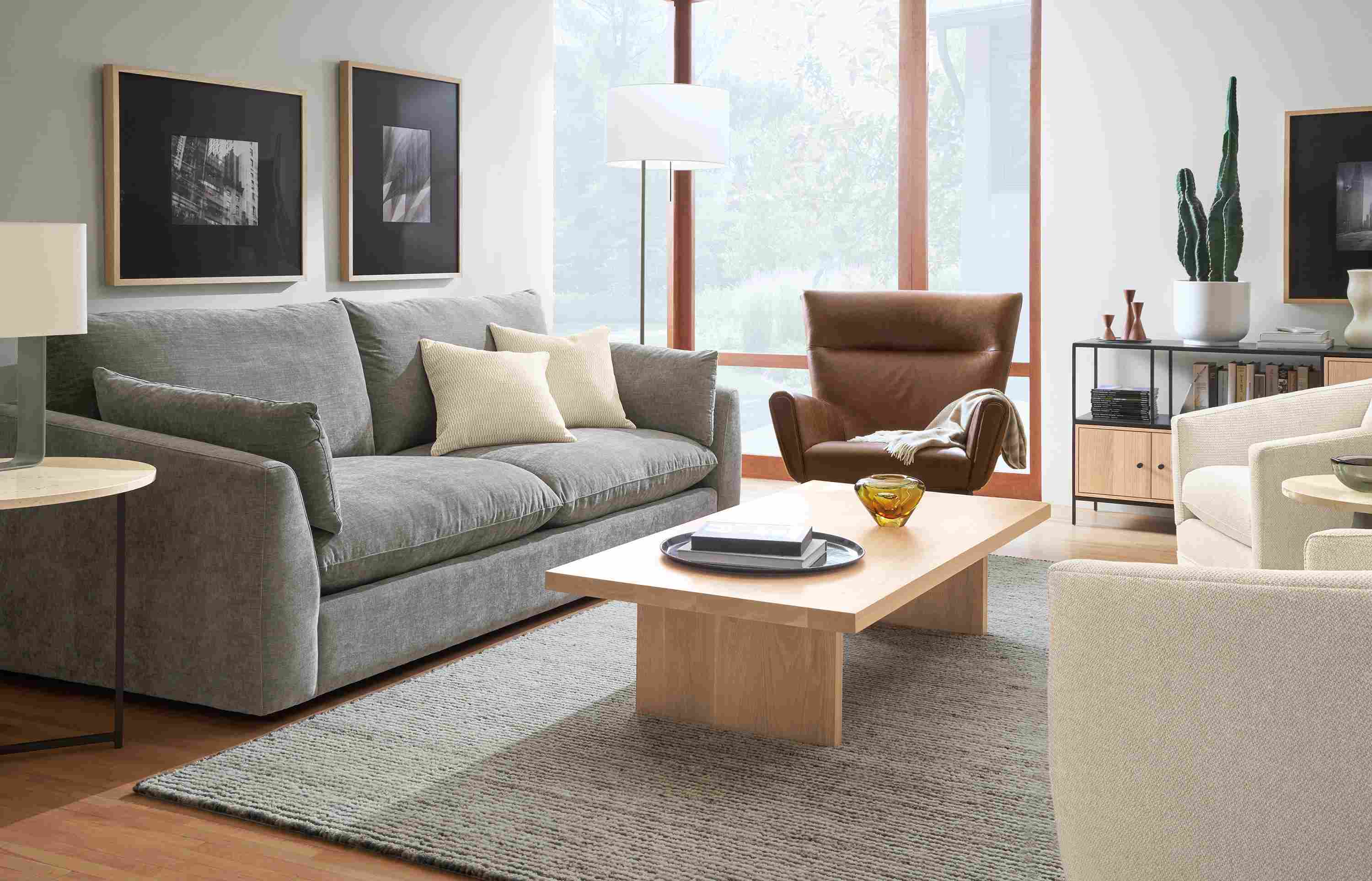 Living room with Weber sofa in Mori Graphite, Boden chair in Palermo Bourbon leather and Corbett Coffee table in  white oak.