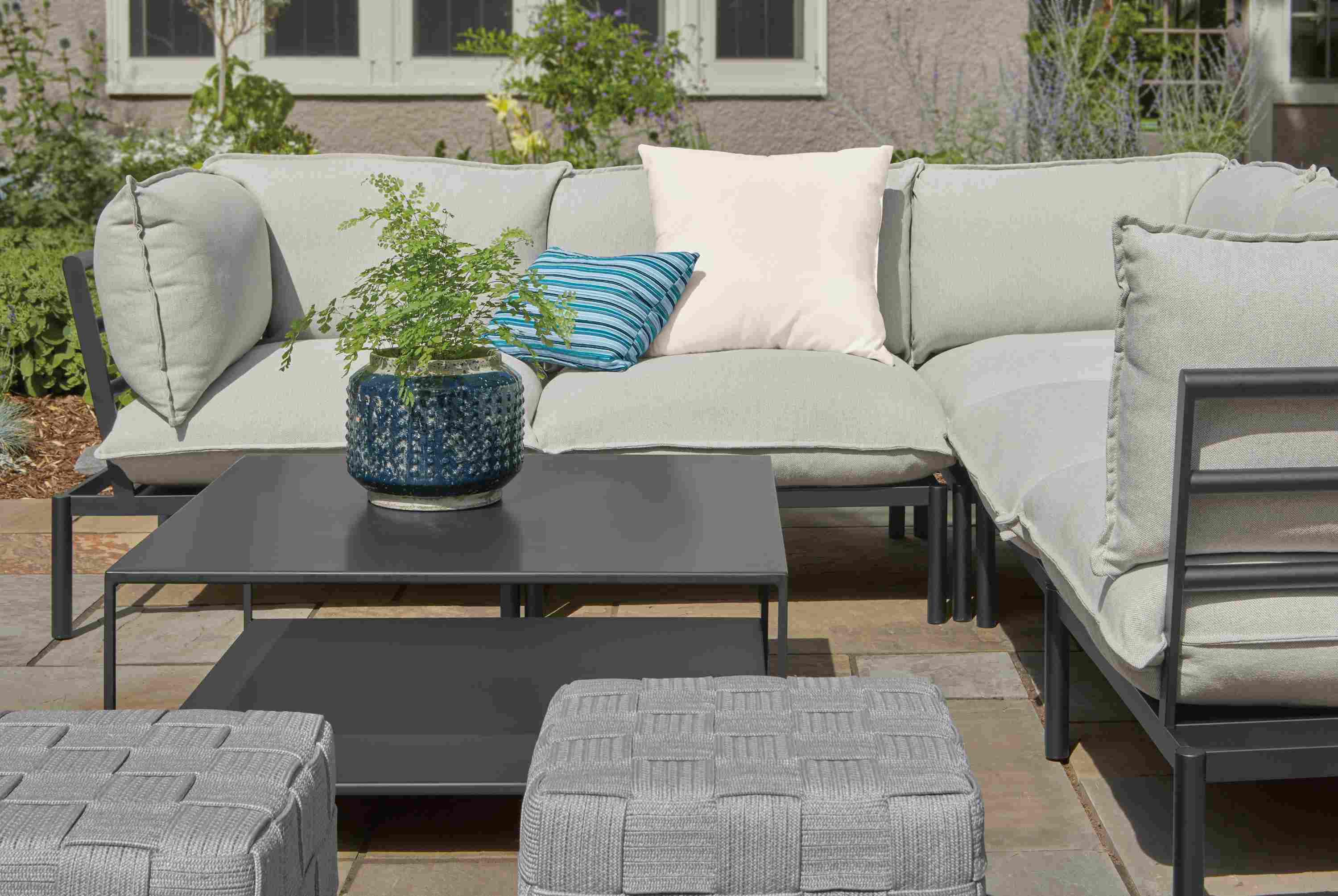 Slate patio with Westbrook modular sectional, Slim outdoor coffee table, Flet Ottoman.