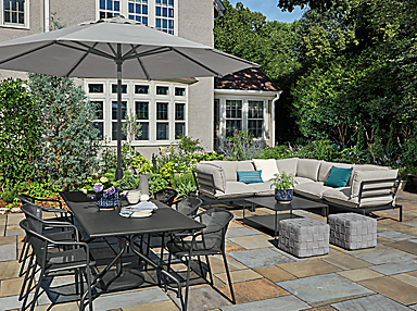 outdoor setting including kona extension table, theo dining chairs, oahu umbrella.