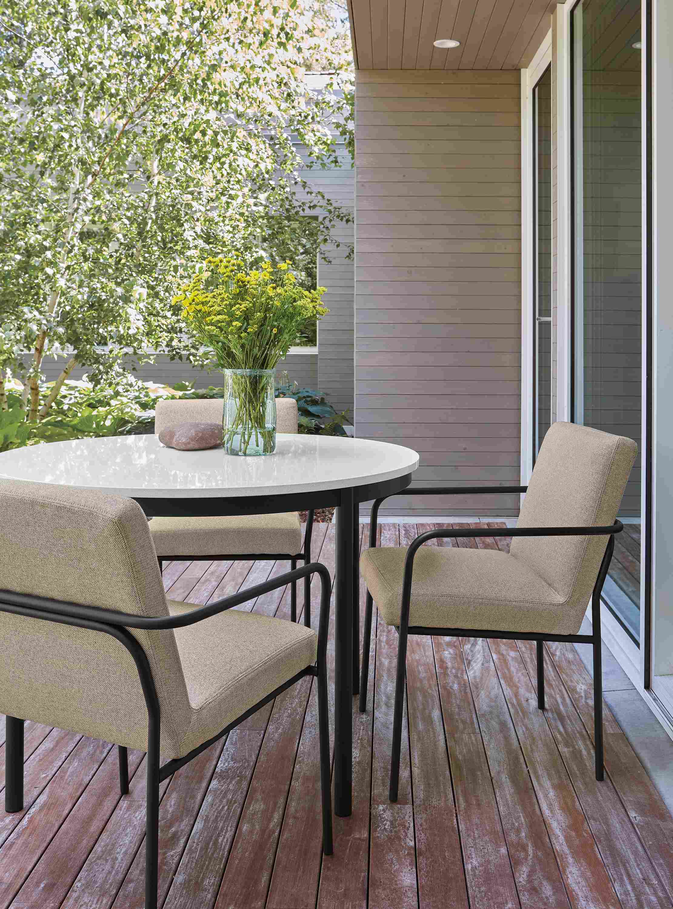 Home deck with Westbrook 42-diameter table in graphite and white quartz and 2 Joel arm chairs in Mist Oatmeal.