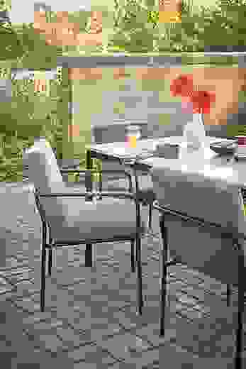 outdoor dining space with joel armchairs in pelham graphite fabric, and Westbrook table.