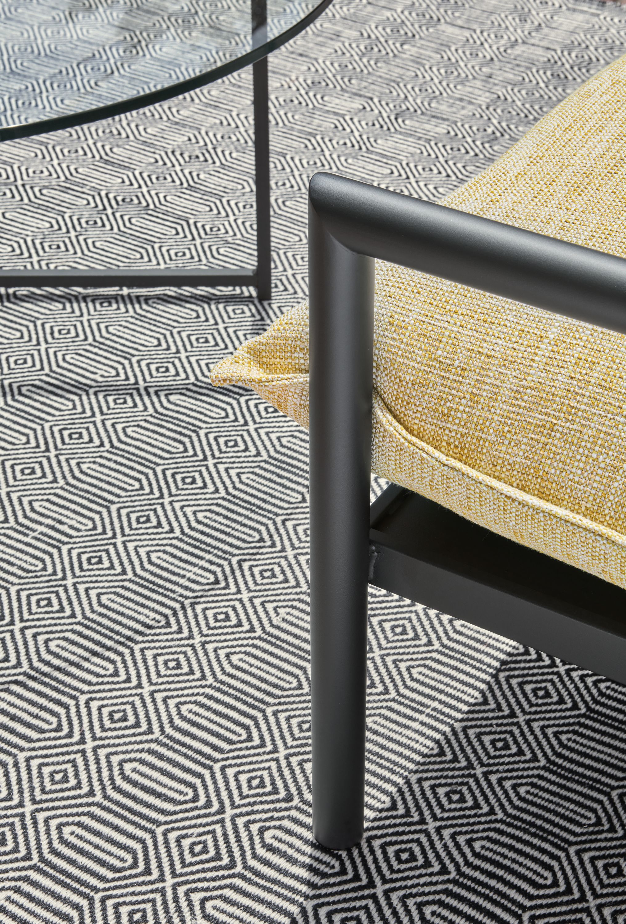 Patio with detail of Westbrook sofa, classic coffee table, sequence rug in Ivory/Black.