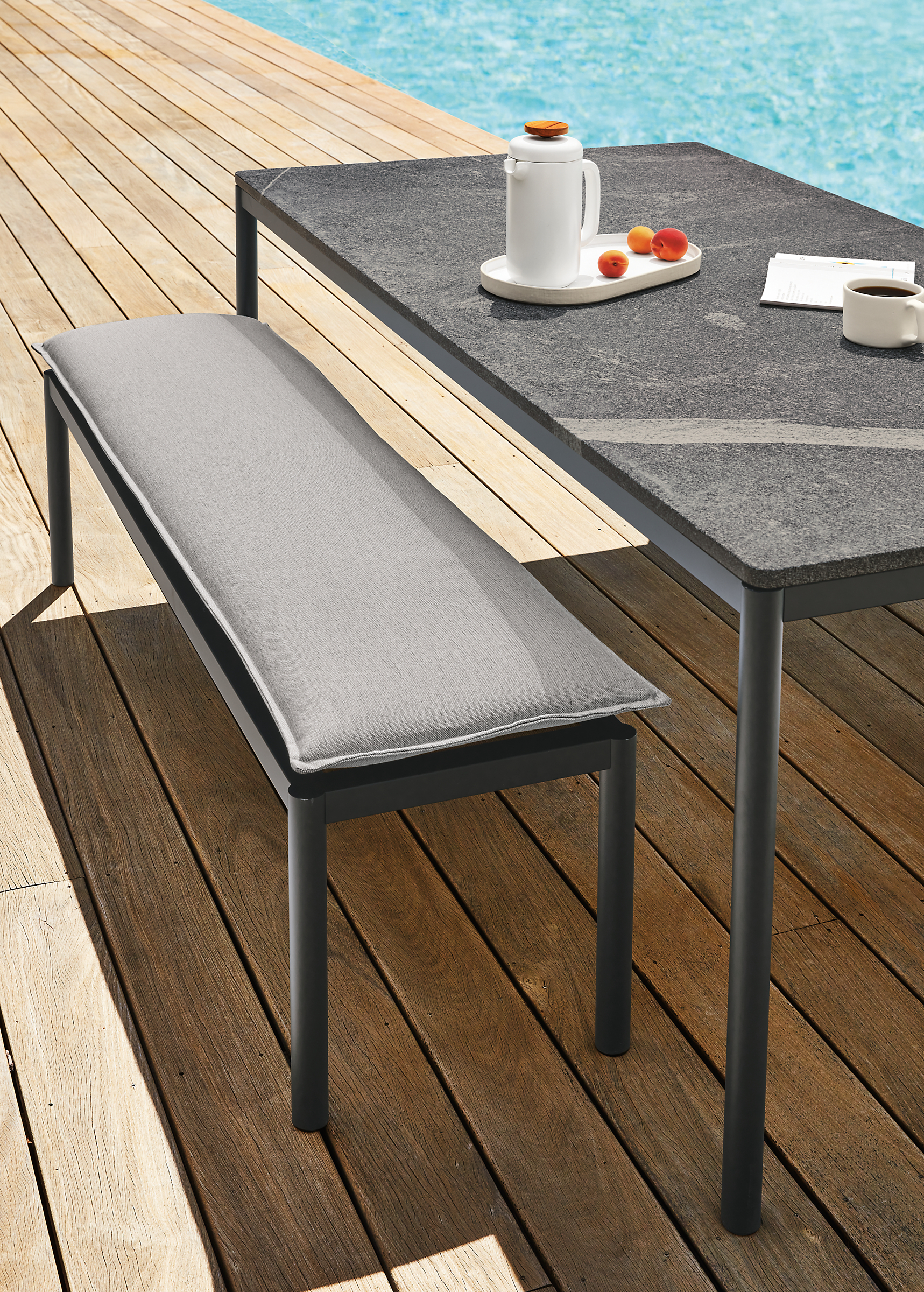 Westbrook outdoor table and bench in graphite with Pelham smoke cushion and Elegant grey granite table top.