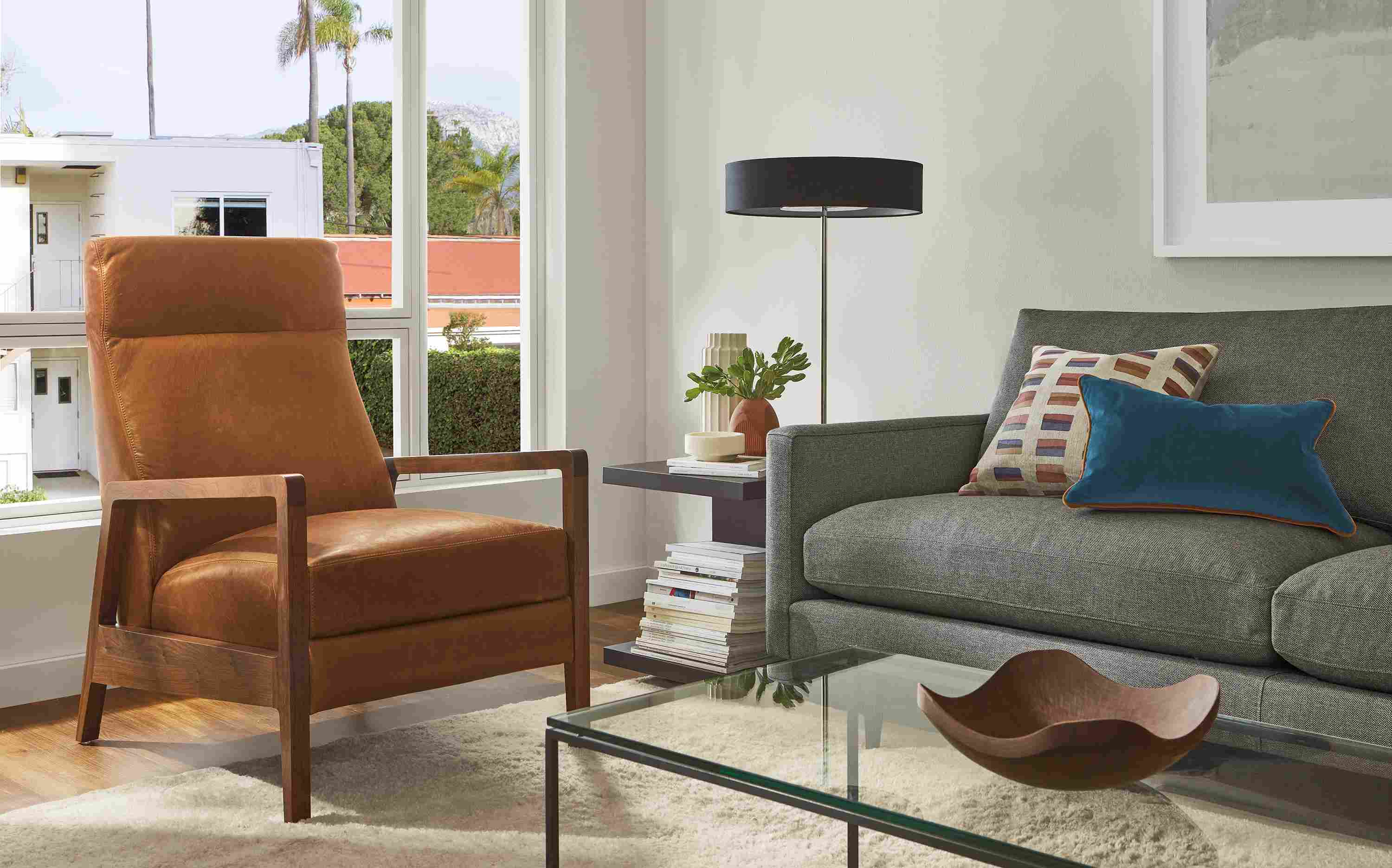 Living room with Westport recliner in walnut and Cyrus Pecan leather, Jasper sofa, Cohen table lamp.