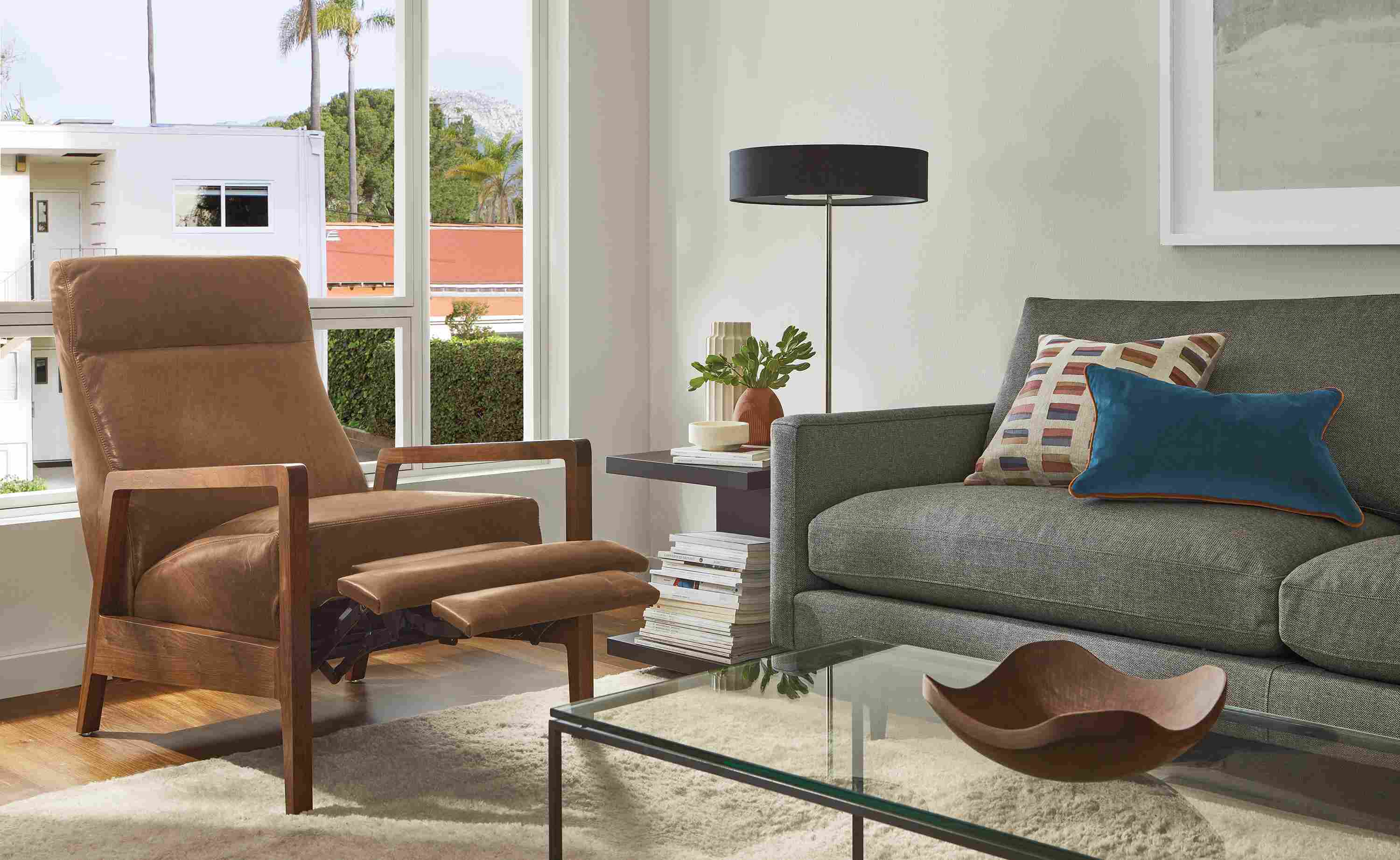 Living room with extended Westport recliner in walnut and leather, Jasper sofa, Cohen table lamp.