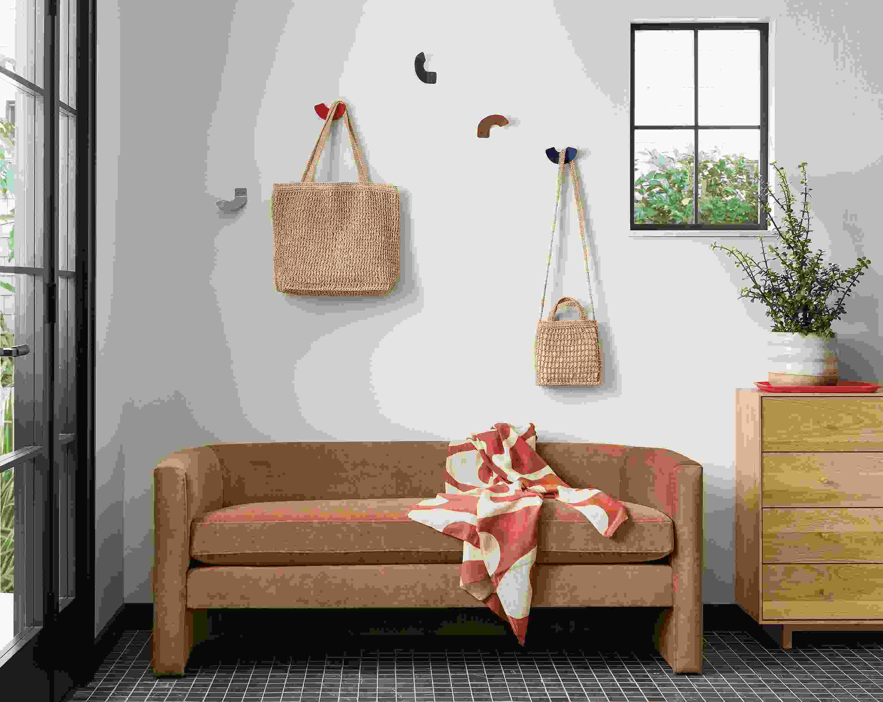 Entryway with Silva bench in velvet and Whim wall hooks above it.