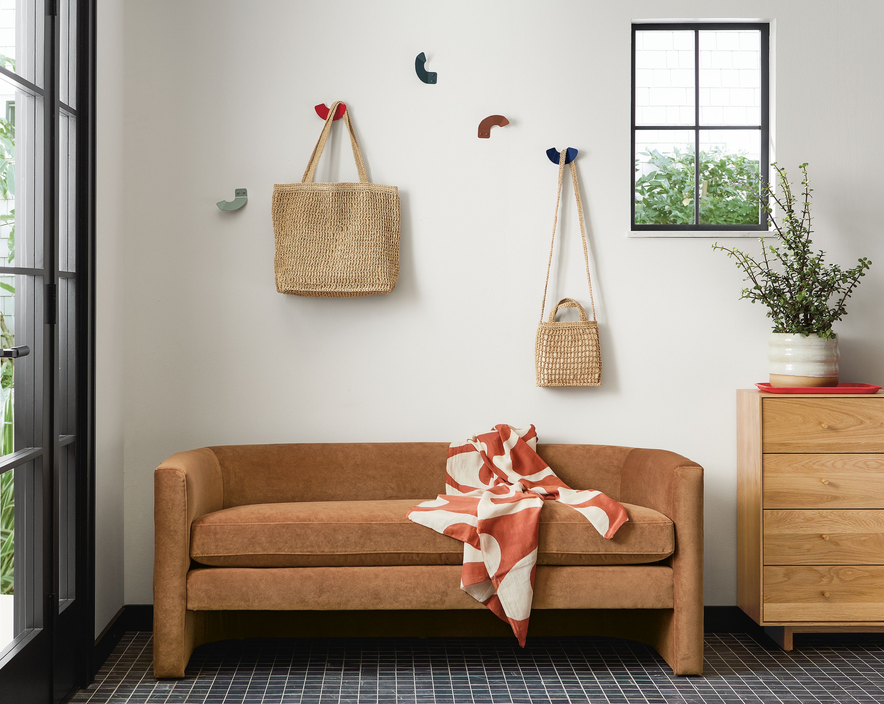 Entryway with Silva bench in velvet and Whim wall hooks above it.