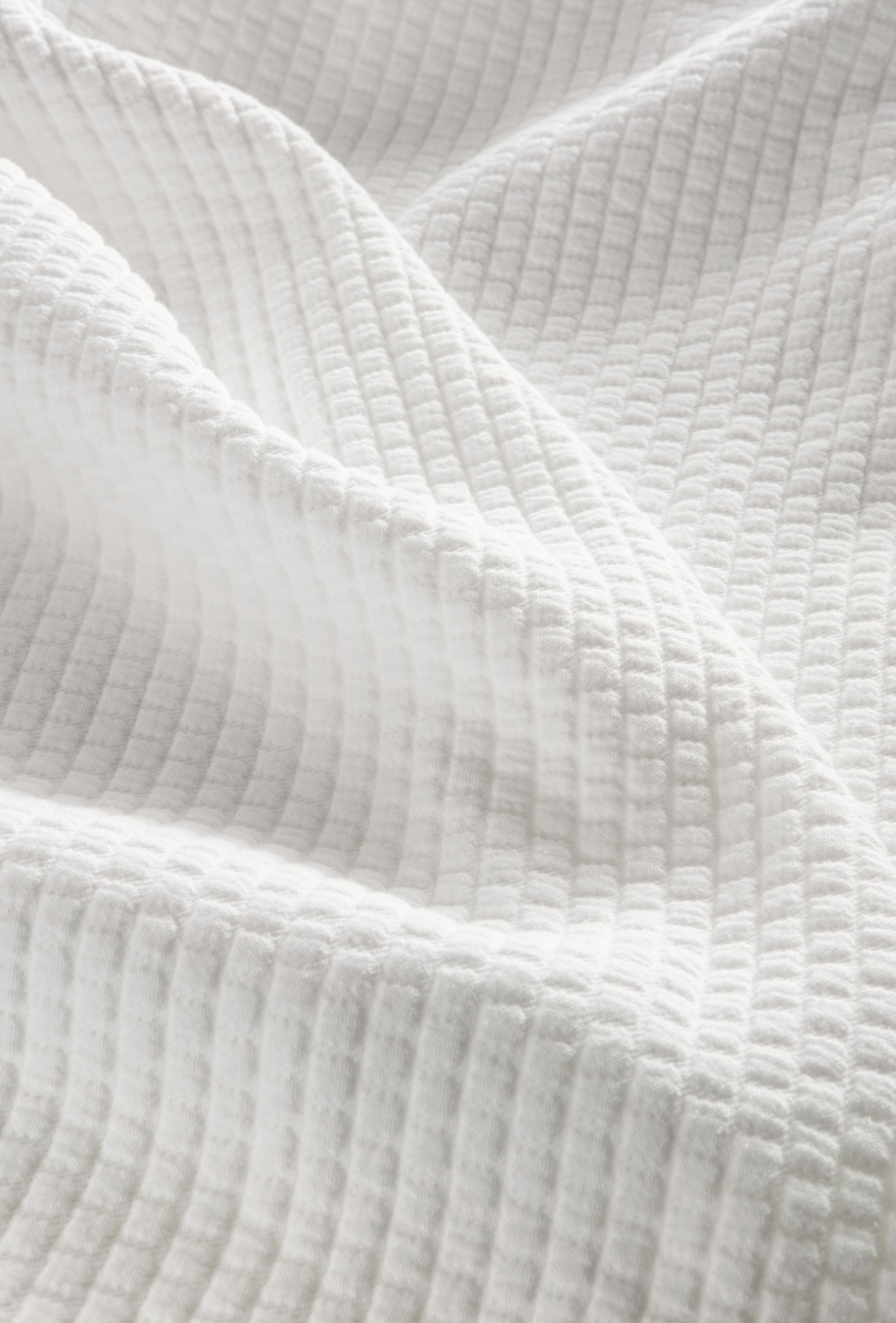 Detail of Whitemore matelasse coverlet in white.