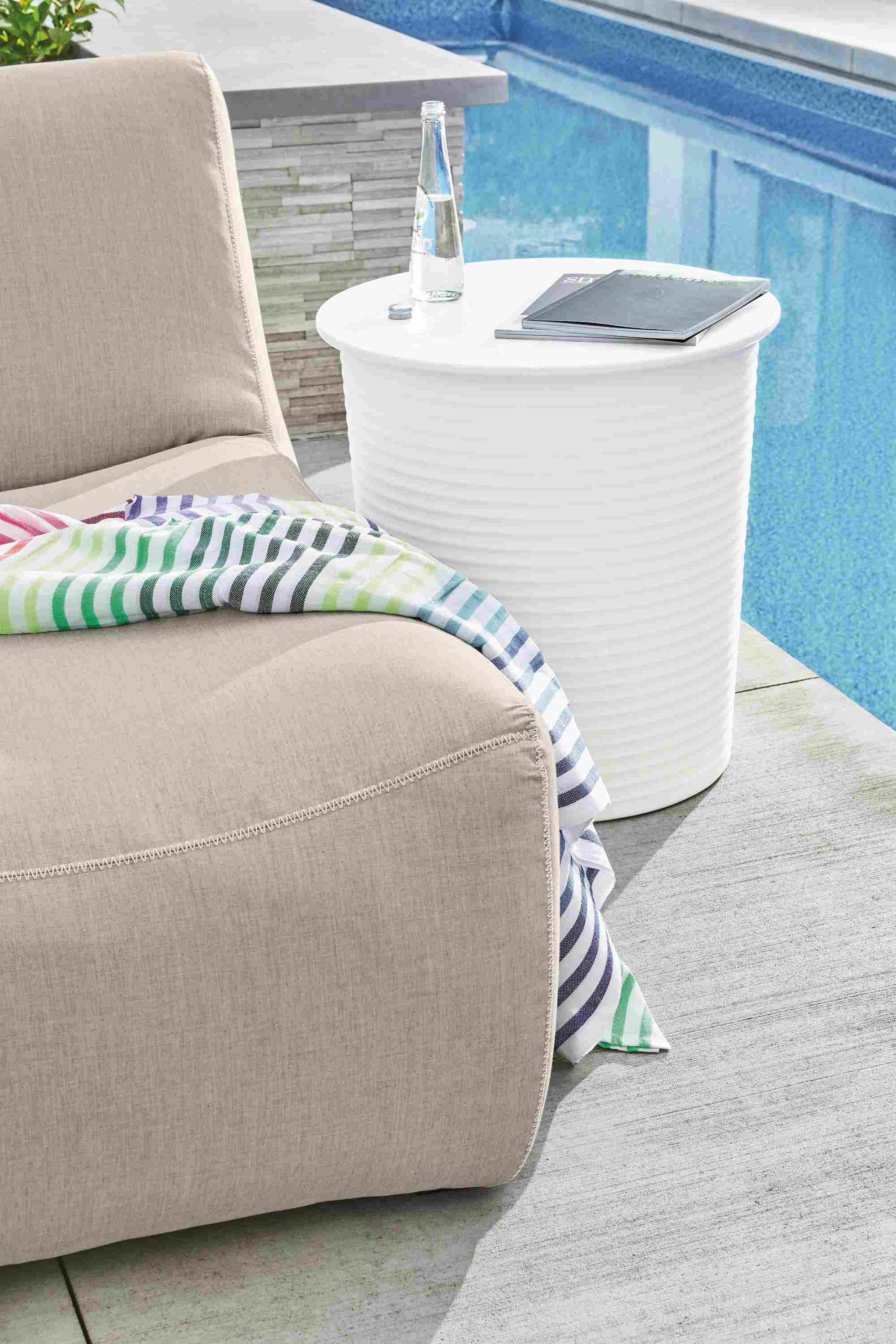 Detail of white Willa planter in white sitting plantside.