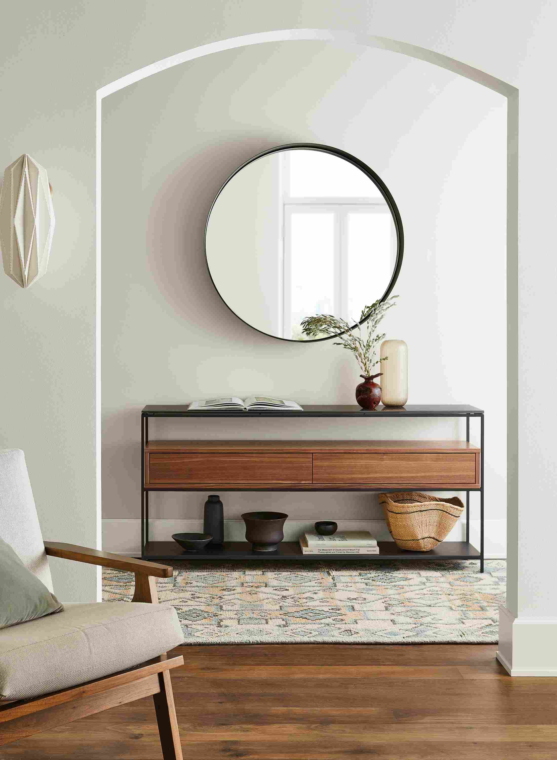 Room setting including Williams console table, Sanna chair, Reeves mirror and Ona rug.