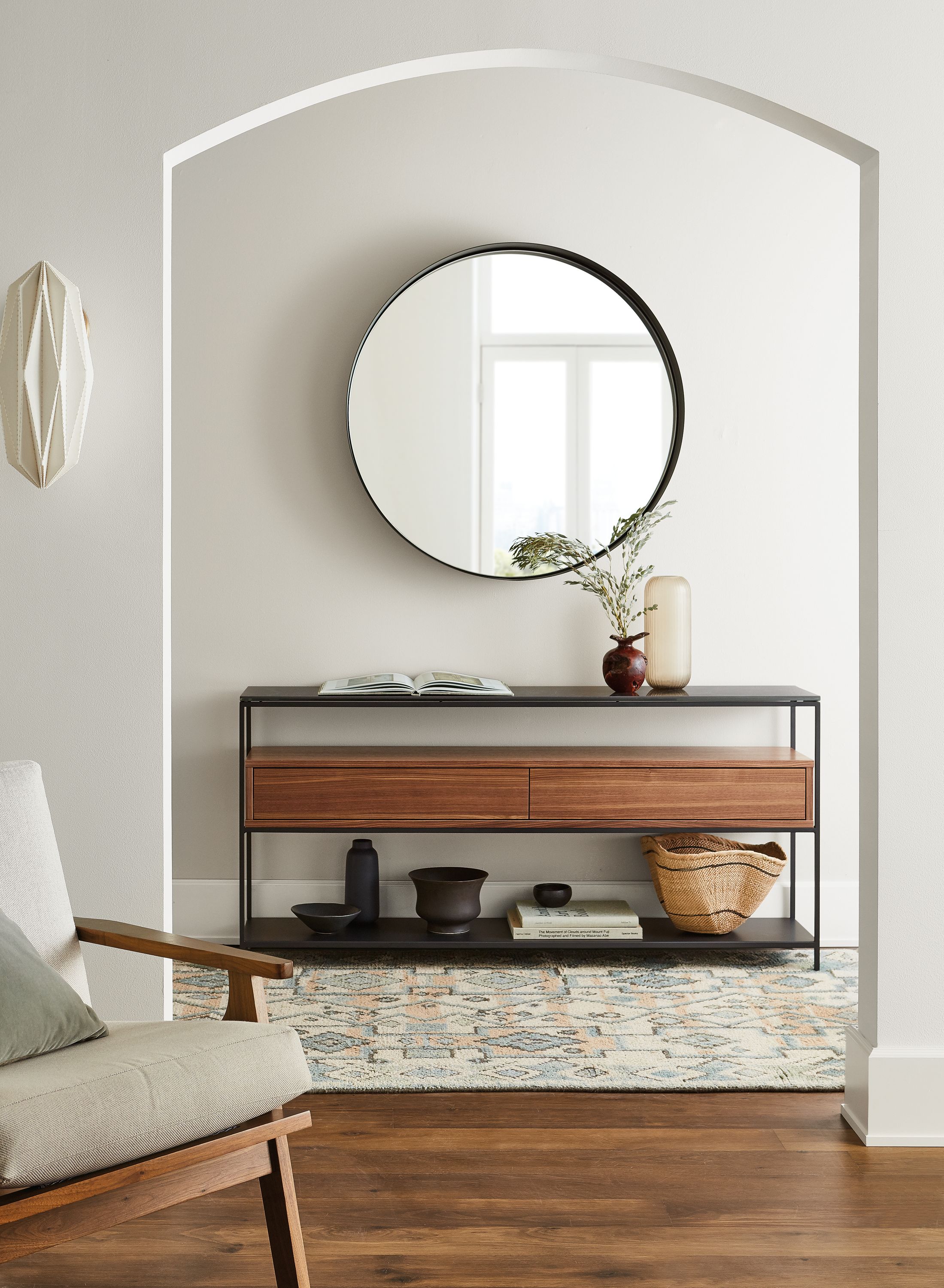 room setting including williams console table, sanna chair, reeves mirror, ona rug.